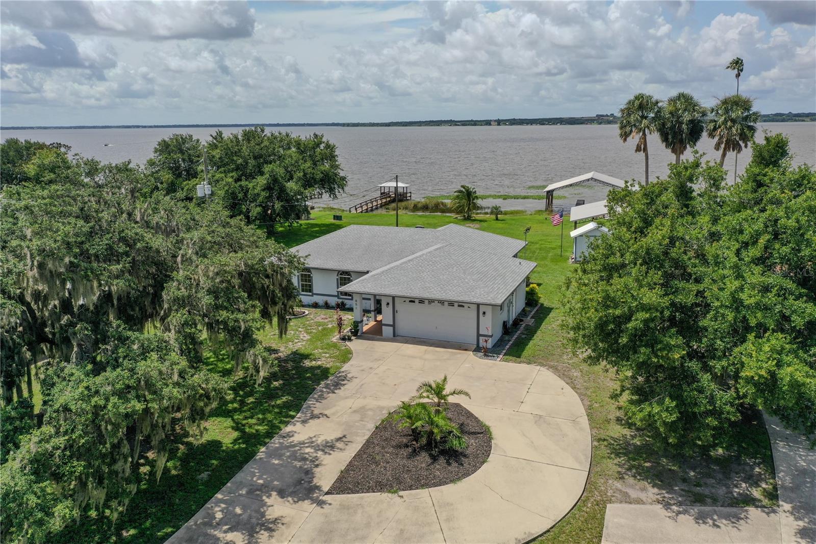 Calling all pilots and water enthusiasts! Imagine landing your floatplane right at your doorstep, where adventure meets tranquility on the shimmering shores of Lake Reedy. This stunning three-bedroom, 2.5-bathroom retreat is not just a home; it's an invitation to a lifestyle filled with endless exploration and serene relaxation. As you step inside, the warmth of updated laminate flooring greets you, flowing effortlessly throughout the spacious layout. The kitchen, a culinary haven, features elegant granite countertops, stainless steel appliances, and a propane tank that fuels the stove, ensuring your cooking experiences are both enjoyable and efficient. Picture yourself whipping up gourmet meals while soaking in the captivating lake views. Each bedroom is thoughtfully designed to provide a peaceful sanctuary, bathed in natural light, with each window framing picturesque scenery of the lake. The bathrooms, adorned with stylish tile, offer a refreshing retreat to unwind after a day of boating or basking in the sun. The bright Florida room beckons you to enjoy your morning coffee surrounded by nature, while the screened-in lanai invites you to host gatherings filled with laughter and joy. Step outside to the lakeside fire pit area, where you can share stories and create lasting memories against the backdrop of stunning sunsets. For the adventurous spirit, the covered dock awaits, perfectly equipped for floatplanes, giving you the freedom to explore the waters at a moment's notice. A separate well provides irrigation for your landscaping needs and fresh water at the dock, ensuring you’re always connected to the natural beauty surrounding you. With a workshop/storage building for your hobbies and a lifestyle that balances leisure and exploration, this property is a rare gem. Located in a community that embraces both tranquility and access to local attractions, your dreams of lakeside living can become reality. Are you ready to elevate your lifestyle in this lakeside paradise? Schedule a visit today and discover the charm and adventure that await you!