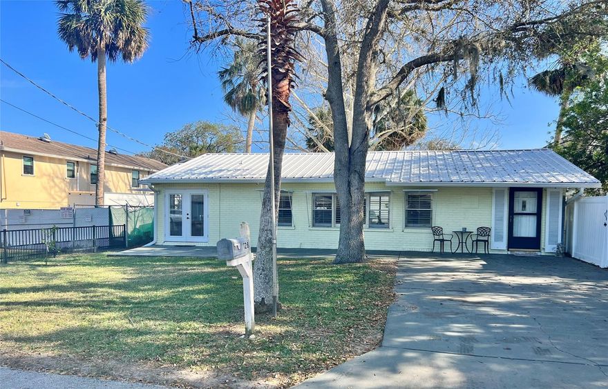 Come see this fantastic 2 Bedroom / 1 Bath home just steps away from the River! In a fantastic location, you can enjoy the river breeze from the front porch and a take a nice stroll on the walkway along the river to the exercise path or to watch the dolphins. Fully white vinyl fenced in yard with a double gate wheel opening for easy access to store all your toys, boat, RV its got the space for it and NO HOA!!  New AC installed in 2021, all white plantation shutters on every window and Metal Roof and the complete front side of the home posses Bahama Hurricane Shutters!!  Kitchen was completely renovated with granite counter tops and white shaker cabinets and new stainless steel appliances in 2020.  Freshly painted in bedrooms and bathroom and floors thru out is travertine marble, bathroom floor is granite.  NO STORM damage with either storm and did NOT flood. A nice little gem!!  All information is deemed correct but not guaranteed ;Water: City