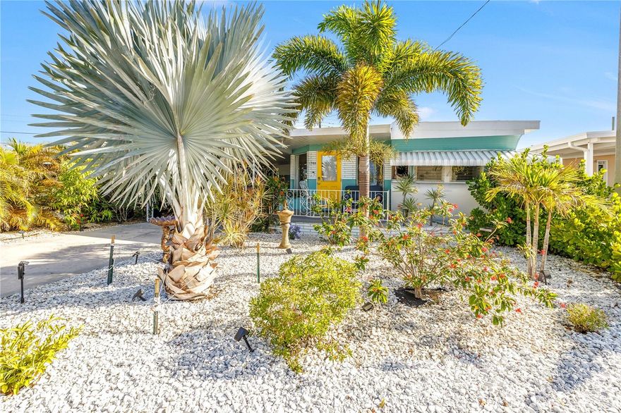 Step into vintage charm with a story to tell—where character, flexibility, and a true sense of Florida living come together in one unforgettable home.

Welcome to this one-of-a-kind 1958 Kropf El Dorado located in the highly sought-after Trailer Estates community. With only three owners, this 2 bedroom, 2 bath home offers a rare blend of original craftsmanship and thoughtful updates.

Inside, you’ll find unique details throughout including curved glass windows in the front dining area, original wood ceilings and walls, and solid copper hardware. The dining space features mahogany beams, recessed lighting, and a built-in clock tucked into a cupboard door. Both bedrooms include built-in dressers, dual closets, and generous overhead storage with original wood shelving. The main bathroom maintains its vintage layout with updated flooring, toilet, and fixtures.

The lower-level living area, once an outdoor porch, has been enclosed to create additional flexible living space while still showcasing part of the original exterior trailer wall and entry detail. The attached shed area includes a washer and dryer, hot water heater, utility sink, toilet, and separate shower stall.

Outside, the property has been transformed into a tropical-inspired setting with mature landscaping, bamboo for added privacy, and thoughtful enhancements throughout. An outdoor shower is tucked beneath the palms, and a decorative fountain in the front yard adds to the ambiance. Drip irrigation, solar lighting, and select exterior lighting features are set on timers with Bluetooth capability. The covered carport offers a tall ceiling along with built-in and overhead storage, and a rear brick barrier has been added for drainage control.

Recent updates include a new air conditioning system in 2023, an updated electrical panel completed approximately 2017–2018, and a roof replacement on the additions in August 2025.

Trailer Estates offers an active lifestyle with amenities including a community pool, shuffleboard, woodshop, frequent social events, and a marina with boat slip availability at a discounted rate.