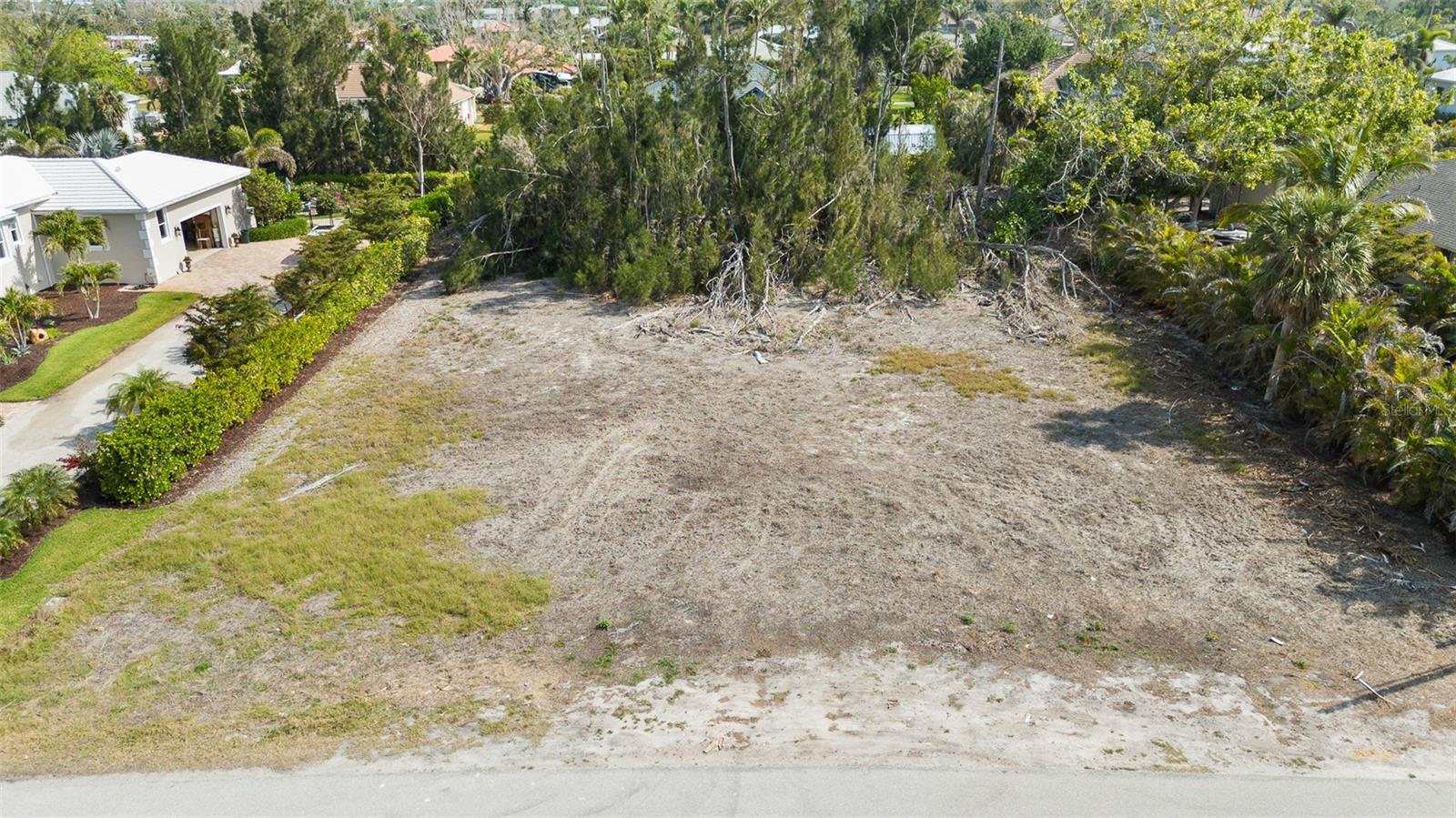 Nestled in the heart of historic Placida, this spacious 0.57-acre lot offers a rare opportunity to build your dream home in one of Southwest Florida’s most charming and timeless coastal communities. Located within a quiet, well-established neighborhood that borders the Intracoastal Waterway, the property combines natural beauty, historical character, and relaxed coastal living. Although the lot itself is not directly on the water, it enjoys close proximity to marinas, public boat ramps, and stunning Intracoastal views, placing world-class boating, fishing, and island-hopping adventures right at your fingertips. The neighborhood is known for its canopy of mature oaks, palms and iconic banyan trees, creating a lush, shaded setting that reflects the authentic spirit of Old Florida. Classic cottages, winding streets, and native landscaping make this a truly unique place to call home. With 0.57 acres of land, there's plenty of space to design a custom home, tropical garden, pool, or even a detached garage or guest suite. The property is located in a community with a voluntary HOA, offering the benefits of a well-kept neighborhood without the burden of mandatory fees. Just minutes away, you’ll find Boca Grande, Gasparilla Island, golf courses, beaches, nature preserves, and local restaurants—all contributing to the area’s laid-back, coastal lifestyle. This is a rare opportunity to own land in one of Placida’s most sought-after and storied neighborhoods. Build your legacy beneath the banyan trees, where history, nature, and the Intracoastal come together in perfect harmony.