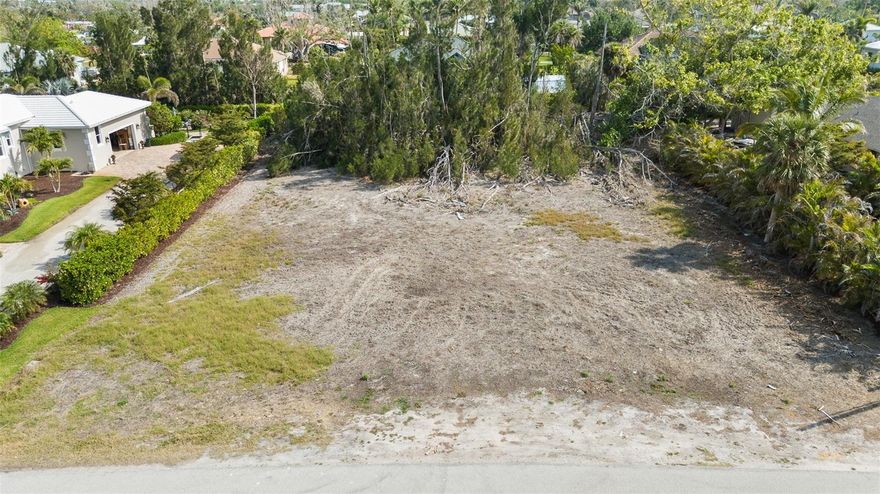 Nestled in the heart of historic Placida, this spacious 0.57-acre lot offers a rare opportunity to build your dream home in one of Southwest Florida’s most charming and timeless coastal communities. Located within a quiet, well-established neighborhood that borders the Intracoastal Waterway, the property combines natural beauty, historical character, and relaxed coastal living. Although the lot itself is not directly on the water, it enjoys close proximity to marinas, public boat ramps, and stunning Intracoastal views, placing world-class boating, fishing, and island-hopping adventures right at your fingertips. The neighborhood is known for its canopy of mature oaks, palms and iconic banyan trees, creating a lush, shaded setting that reflects the authentic spirit of Old Florida. Classic cottages, winding streets, and native landscaping make this a truly unique place to call home. With 0.57 acres of land, there's plenty of space to design a custom home, tropical garden, pool, or even a detached garage or guest suite. The property is located in a community with a voluntary HOA, offering the benefits of a well-kept neighborhood. Just minutes away, you’ll find Boca Grande, Gasparilla Island, golf courses, beaches, nature preserves, and local restaurants—all contributing to the area’s laid-back, coastal lifestyle. This is a rare opportunity to own land in one of Placida’s most sought-after and storied neighborhoods. Build your legacy beneath the banyan trees, where history, nature, and the Intracoastal come together in perfect harmony.