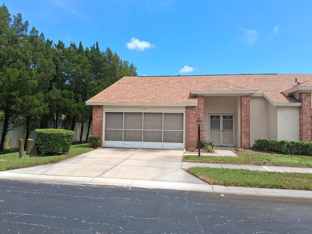 Need to downsize to a condo that’s bigger than a shoe box? With 1728 sq ft of living area this is easily the largest 55+ condo in the New Port Richey area. Plus, it is a LAKEFRONT end unit (more light!) and has an ATTACHED 2-CAR GARAGE. New in 2025: roof, AC, bedroom carpets, & interior paint. The 16’x15’ primary bedroom has a private bath with dual sinks, and TWO walk-in closets. The 12’x12’ guest bedroom also has a LARGE WALK-IN CLOSET. The kitchen features a sweet breakfast area with a bay window. The enormous great room has laminate flooring while the kitchen & baths have ceramic tile. You also get access to the Heritage Lake community facilities: tennis courts, shuffleboard, billiards, and bocce ball, and a large, LAKE-FRONT HEATED POOL, sauna, and FISHING PIER! Finally, the trendy shopping and dining of the Trinity area is only 5 minutes away. All this for less than $2000 per month!