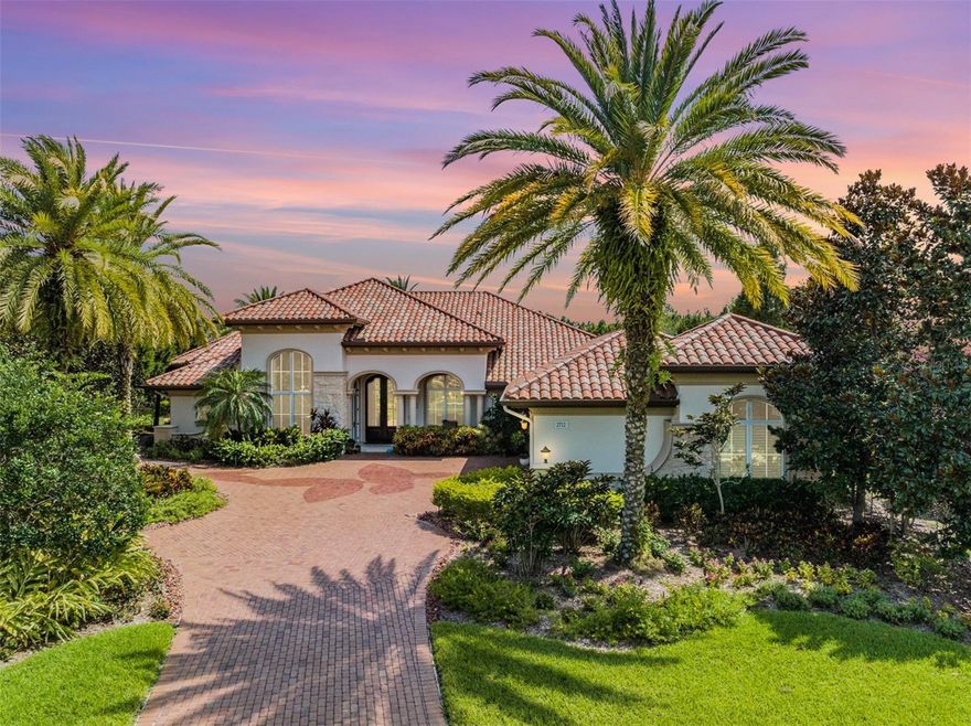 Luxury Abounds in this magnificent Award-Winning Marc Rutenburg “Castaway III” Model Home, located in the gated community of Hawks Landing. Nestled on the Largest Pond-Front Lot in the community, this former Model Home is more than a statement of luxury, it's a living masterpiece awaiting its next discerning owner. Oversized Pavered Driveway leads to the 3 Car Garage of this sprawling 4,528 Sqft Estate. This home features 4 Bedrooms, an Office, Bonus/Media Room, 3 Baths, 3 Car Garage, High Impact Windows and Doors, Solar Panels, and countless other Energy Efficient Features (a Florida Green Building Certified Home). Luxurious Custom Front Doors lead into a grand foyer with soaring ceilings, lighted Art Niches, and Custom Millwork, setting the stage for the opulent interiors that await. The formal living room features a modern stacked stone “water vapor” fireplace, and floor-to-ceiling windows that flood the space with natural light. The adjoining dining area is perfect for entertaining and offers an elegant setting with custom woodwork and designer finishes. Each room in this palatial residence has been crafted with meticulous attention to detail, offering an array of amenities for the most discerning buyer. Chef's Dream Kitchen equipped with top-of-the-line stainless steel appliances, custom cabinetry in several styles, Carrara Marble countertops, designer backsplash, full pantry, coffee station, and a sprawling "Acid Wash" Marble island countertop with bar seating. Family Room with a entertainment center & custom built ins that houses the Top-of-the-line Crestron Home Automation System to controls all lighting and media. Escape to the Owner’s Suite which features rich wood flooring, and a private sitting area overlooking the sparkling pool/pond. The master bath provides the ultimate Spa-Like experience with rich Custom Cabinets with Under-mount lighting, a Freestanding Sculpture Tub with Glass Tile Wall, and much more. Step into the enormous, circular walk in shower with dual shower heads, and decorative wall of glass tiles and bench seating. Two walk in master closets with custom organizers. Adjacent to the Master suite is the Executive Style Office, featuring the most gorgeous custom built-ins, a closet, rich wood flooring, and custom millwork and architectural details. The three-way split floor plan provides three Additional bedrooms with private luxury baths. The laundry room is conveniently located right off the garage entry featuring front load washer and dryer, farm style sink, and plenty of extra storage. The Bonus/Media Room at the back of the home has endless views of the pond, and boasts custom woodwork, built ins, and entertainment area with sink, fridge, and ice-maker. The Resort Style Pool area rivals that of a 5-Star Resort, with its lagoon-style sparkling pool and personal stacked stone spa graced by a tranquil waterfall feature. The travertine deck leads to multiple covered entertaining spaces, where columns rise to meet the rich, wood-paneled ceiling, creating an atmosphere of grandeur for the al fresco dining and seating areas. Anchoring this oasis is the outdoor gourmet kitchen, with Custom Stone Wall, Stone Countertop, and New Grill. Whole House Generator (Kohler). The Preserve at Hawks Landing is a gated community located in the highly sought after East Lake High School district. Convenient to shopping, beaches, golf, & airport. See Feature Sheet for More. All Furnishings Negotiable.