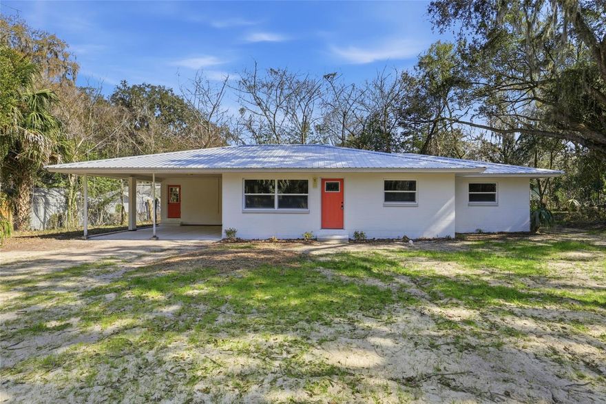This fully renovated home is located TWO BLOCKS from Newnan’s Lake and is NOT in a designated flood zone. Situated in a quiet neighborhood with no HOA, the property offers convenient access to everyday amenities and is approximately 14 minutes to the University of Florida.  Everything in the home has been replaced or updated in 2025, including roof, electrical and panel, HVAC system, septic system, well, full plumbing repipe, water heater, interior paint and flooring, kitchen, and bathrooms. The interior features an open and functional layout with modern finishes throughout. The updated kitchen includes new cabinetry, countertops, and appliances. Renovated bathrooms include new fixtures and surfaces.  Additional exterior features include a carport and ample yard space. The home is ready for immediate occupancy and reflects comprehensive updates to major systems and living spaces.