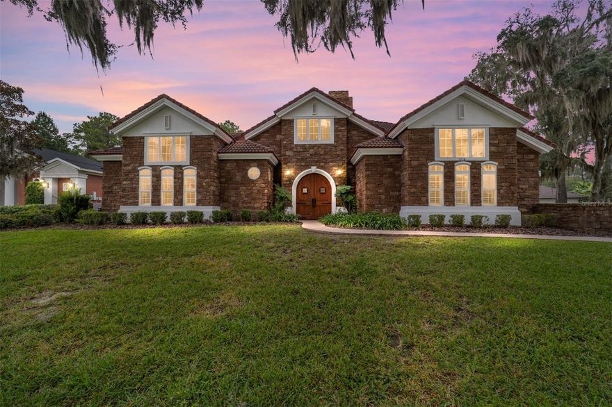 One or more photo(s) has been virtually staged. Welcome Home to 1718 SW 27th Street, Ocala, FL 34471 — located in the highly desirable White Oak Village subdivision. This stunning French Manor–style residence offers 5 bedrooms, 4.5 bathrooms, an office, and a flex room across 4,087 sq. ft. of finished living space (5,440 sq. ft. under roof).

Step through the custom wood-arched entry doors into your private courtyard oasis, featuring a spectacular walk-in swimming pool, two-sided fireplace, and a fully equipped entertainment room with double-door access to the great room, dining area, and gourmet kitchen. The soaring two-story great room is filled with natural light and showcases elegant architectural details and an open-concept layout that blends luxury and comfort.

The chef’s kitchen features rich wood cabinetry, granite countertops, a spacious island, and stainless-steel appliances. A charming breakfast nook surrounded by built-in cabinetry overlooks the sparkling pool, creating a perfect space for morning coffee. The main-level primary suite includes two walk-in closets and a spa-inspired ensuite with dual vanities, granite countertops, a jetted soaking tub, and a custom glass walk-in shower. French doors provide direct access to the pool and courtyard.

A dedicated home office offers inspiring views of the screened pool area, while a flexible layout allows for multiple living and entertaining options. Upstairs, three additional bedrooms each feature private balconies overlooking the property’s serene surroundings. A separate in-law suite with a private entrance ensures comfort and privacy for guests or extended family.
The resort-style courtyard is truly an entertainer’s paradise—complete with a newly resurfaced waterfall pool, two brand-new pool pumps (2025), and solar/gas pool heating for year-round enjoyment. Relax by the gas fireplace, unwind in the built-in jacuzzi, or host gatherings in multiple lounging areas. Additional features include built-in ceiling speakers, a formal dining room with bar area, and a spacious garage with an electric vehicle charger for modern convenience.

Blending timeless elegance with modern amenities, this exceptional home offers a rare opportunity to enjoy refined living and effortless entertaining in one of Ocala’s most sought-after communities.

Residents of the White Oak Village / Cala Hills community enjoy access to a full-amenity clubhouse, fitness center, and tennis courts. 

Just minutes from shopping, dining and downtown Ocala’s vibrant restaurant scene, with quick access to tranquil outdoor spots like Sholom Park, and approximately 15-minute drive to the renowned World Equestrian Center – Ocala complex, offering upscale dining, shopping, events and resort-style amenities.  Schedule your private showing today.