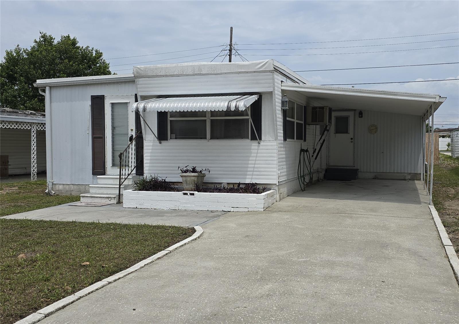 Welcome home to this charming and affordable 3-bedroom, 2-full bath double wide mobile home, offering the perfect blend of comfort and convenience and you OWN THE LAND! Located in the highly sought after family and pet friendly community of Buena Vista , this home is ideal for first-time buyers, snowbirds, downsizers, investors or anyone looking for an affordable housing option. The HOA at $109.50 a quarter covers both twice a week trash collection and street lights.
Key Features:
• Spacious Living Area: The open-concept living/dining room provides ample space for relaxation and entertaining, with large windows that allow natural light to flood the room.
• Kitchen:The well-equipped kitchen includes plenty of cabinet space for storage and counterspace for food prep
• Bedrooms: 3 comfy bedrooms with built in closets, One bedroom boasts its own full bath and separate entrance for privacy.
• Bathrooms: This home offers 2 full bathrooms both with tub/showers
• Outdoor Space: Enjoy the private open patio in the back to enjoy your morning coffee or glass of wine to unwind in the evening. It’s perfect for entertaining grilling for friends and family.
• Parking: Is not a problem with space for 2 cars in the driveway and at least one car in the front.
• Laundry room/workshop/storage: Never go to the laundry mat again with your own concrete laundry room that has room for plenty of storage and electricity for a workshop!
• Community Amenities: Enjoy both club houses located within Buena Vista offering bingo, cards or breakfast on Saturday mornings at the South hall. This active community offers many activities including pickleball, pools tables, shuffleboard and their own library.
• Roof: TPO roof that is 15 years old with a expected lifespan of at least 30 years.
Additional Highlights:
• Family community (no age restrictions)
• No flood zone x500
• Pet-friendly community
• Convenient access to public transportation, schools, shopping, restaurants and a short drive to beaches, Sponge Docks, airports and theme parks.
• Clean 4 point inspection was performed February of 2025
• True much larger square footage is not reflected in the tax records
This home is move-in ready and waiting for you! Schedule your showing today and discover all the possibilities this charming mobile home with land has to offer. Feel like you are on vacation everyday! Florida living at its best! All information is believed to be true and accurate. Buyer/Buyer’s agent to please verify all information
