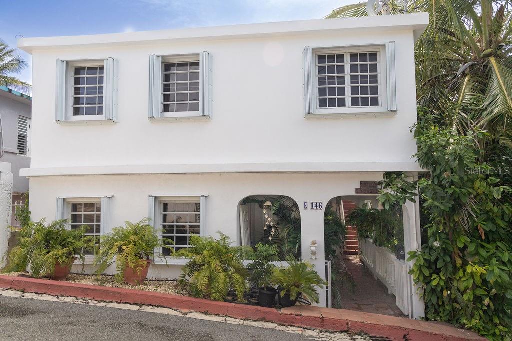 Welcome to Casa Mama Playa, a beautifully sited duplex home that allows for elegant living within the verdant gardens offering modern Caribbean comfort in the heart of Vieques Island. This unique property offers two distinct living spaces, each with its own charm and appeal - perfect for full-time living, vacation rentals, or a combination of both.
The Upper residence has two bedrooms and two and one half bathrooms with a lovely outdoor terrace amongst the jungle. Step into the upstairs apartment and be transported. This sun-kissed apartment offers natural light pouring into every corner. From it's perch above Isabel Segunda, the home offers views of the last Spanish fort built in the Western Hemisphere, and from the rooftop terrace, you'll enjoy vistas of the crystalline ocean and the mainland of Puerto Rico beyond - on clear days, it feels as though you can see forever.
Whether you are enjoying your morning coffee with the sun rising over the water or watching the town light up in the evening, this elevated sanctuary offers serenity and inspiration at every turn.
The Lower residence, ground-level apartment offers a spacious one bedroom one bathroom home with tropical, tranquil terrace retreat nestled among the lush tropical plantings. This charming one-bedroom, one-bathroom space is perfect for guests, long-term rentals or peaceful personal use.
Highlights:
Versatile duplex setup for multi-use living or rental income
Rooftop terrace with panoramic views including El Fortin, reminding you of the island's rich history and enduring magic
Mature landscaping and a private feel
Prime location close to town , shops, and beaches
Bonus space below house for storing a multitude of items as well as the current owners using it as a movie room and office space.
