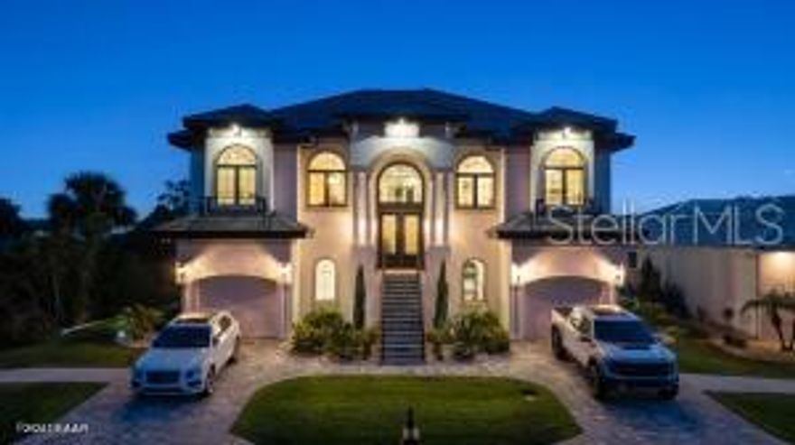 Imagine living in a home where every detail is meticulously crafted to provide the ultimate in luxury and comfort? Welcome to 801 N. Flagler Avenue, a stunning custom-built residence completed in January 2024. Located on a deep-water canal in picturesque Flagler Beach, this 3-bedroom, 3-bathroom home with a 4-car air-conditioned garage is the epitome of modern living. As you step through the double leaded glass doors, you are greeted by a porcelain tile foyer with soaring ceilings and modern light fixtures, setting the stage for the elegance that lies within. Ascend a few steps to discover the open floor plan of the upper floor, where no attention to detail has been spared. The spacious living room with an electric fireplace offers a the perfect spot to entertain guests and easily transitions to the covered, outdoor balcony offering see-through railings, outdoor speakers, and breathtaking views of the canal. The heart of the home is the chef-inspired kitchen, equipped with GE Monogram Energy Star appliances, quartz countertops and a large center island with electrical pop-ups. With 42" upper cabinets, a 6-burner gas cooktop, electric oven, a microwave drawer, soft-close cabinets with pull-out shelving and a 9' x 8.5' pantry, this kitchen is both beautiful and functional. The butler's pantry, featuring a side-by-side fridge, automatic ice drawer, and filtered water pitcher, opens into the formal dining room. The grand primary suite is a sanctuary of its own, featuring a massive walk-in closet and an opulent ensuite bathroom. Relax in the soaking tub, enjoy the spacious glassed-in shower, and appreciate the separate water closet and his-and-her vanities. Kohler and Savoy House fixtures add a touch of elegance, and built-in bidets in all commodes ensure comfort and convenience.
Rounding out the remainder of the upper floor, you will find a sizable guest bedroom and second full bathroom with a walk-in glass shower and pedestal vanity. The laundry room, equipped with two lazy Susans, a built-in iron, sink, and stacking washer and dryer, adds practical convenience to your daily routine. Lastly, there is an office with east facing windows that flood the room with natural light.
The lower level includes a versatile bonus storage/craft room, a cozy family room/gym, a third full bathroom, and a third bedroom currently used as a secondary office. The covered outdoor patio provides additional space for leisure and relaxation. Stroll along a pavered walkway to your private boathouse. The 6' wrought iron rear-yard fence with locking gates ensures your yard is your own private sanctuary.
Additional highlights include porcelain tile wood-look floors throughout, back-lit custom tray ceilings, modern crown moldings, tall baseboards, and picture frame molding on several walls. Hurricane-impact doors, a 38kw Honeywell whole house generator fed by a 500 gallon propane tank and hurricane-impact roll-out casement windows provide peace of mind and security while retaining costal charm. Smart features include programmable thermostats, two tankless gas hot water heaters, garage door lifts and a security system featuring six outdoor cameras. With a four car air conditioned garage with an interior safe room and recessed LED light fixtures, you may never venture anywhere else. This home truly offers the perfect combination of luxury, comfort, size and location. Based on contractual negotiation, seller is willing to provide a credit to install an elevator.