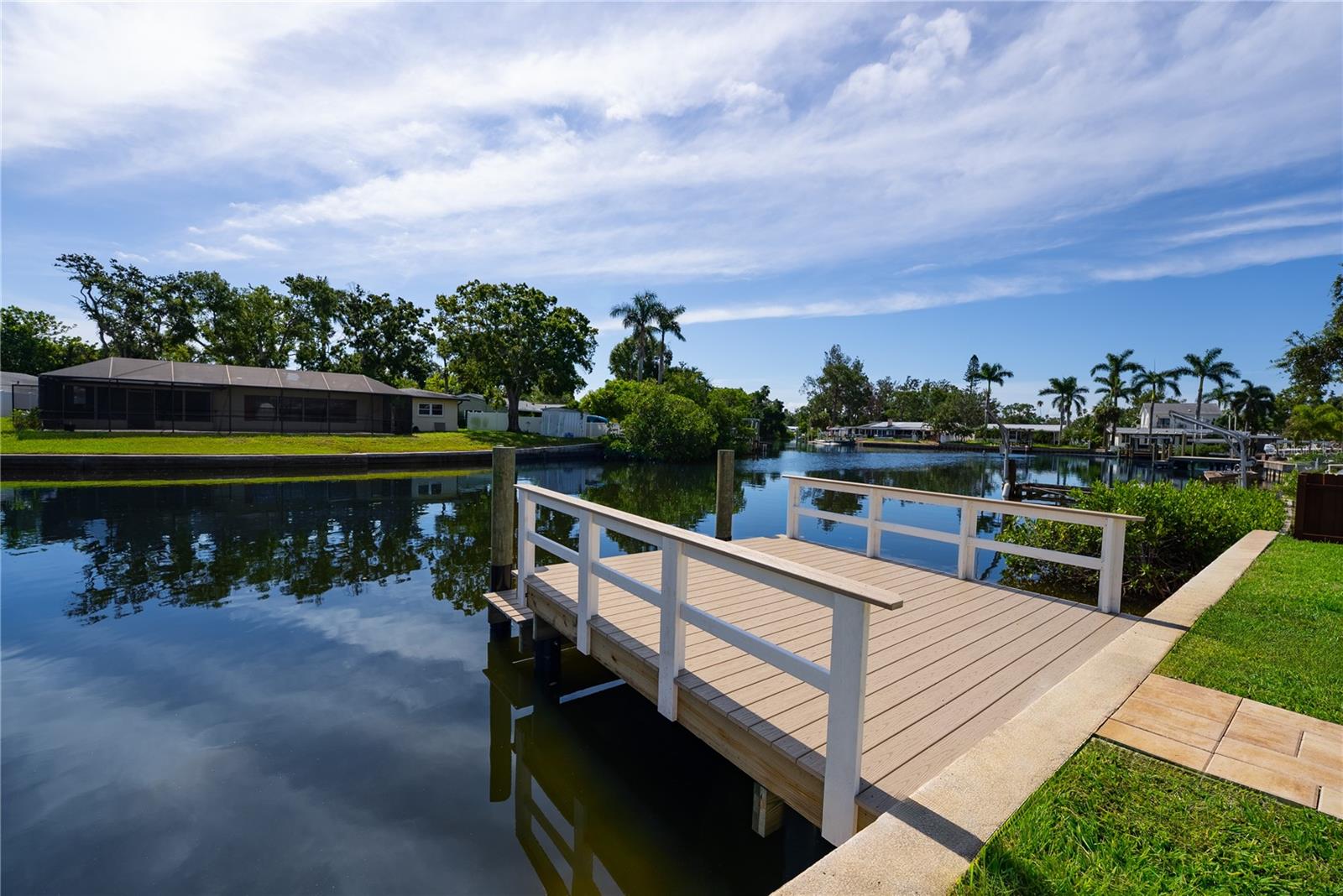 This stunning, fully renovated home in this highly desirable neighborhood of St. Petersburg offers an unbeatable combination of modern luxury, waterfront lifestyle, and prime location. Nestled along a tranquil canal with direct access to Tampa Bay, this coastal gem is a boater’s paradise—just minutes from open water. From the moment you step inside, you’ll be captivated by the open-concept layout, drenched in natural light and thoughtfully designed for both comfort and style. Wide-plank oak luxury vinyl flooring runs throughout, setting the tone for the home’s warm yet modern aesthetic. Sleek fixtures, designer lighting, and high-end finishes elevate every space, giving the entire home a refined, move-in-ready appeal.
The show-stopping chef’s kitchen is the heart of the home, featuring custom cabinetry, gleaming quartz countertops, stainless steel appliances, and an oversized island that’s perfect for entertaining. The spacious waterfront primary suite is a true retreat, offering tranquil canal views, direct access to the pool, and a luxurious spa-inspired en suite bath with double vanities, a frameless glass walk-in shower, and elegant tilework. Step outside to your private backyard oasis where an in-ground pool, tropical landscaping, and a generous patio area invite you to relax, entertain, or take in the sunset.
Located in one of St. Petersburg’s most charming waterfront communities, you’re just moments from the Recreation Center, Denver Park’s tennis courts and playground, and the Islander Market Shopping Center. Downtown St. Pete—with its vibrant arts scene, top-rated restaurants, and scenic waterfront parks—is just a short drive or boat ride away. Whether you’re paddle boarding through the neighborhood canals, hosting poolside gatherings, or exploring the best of Florida’s Gulf Coast, this home delivers the ultimate blend of lifestyle, luxury, and location.