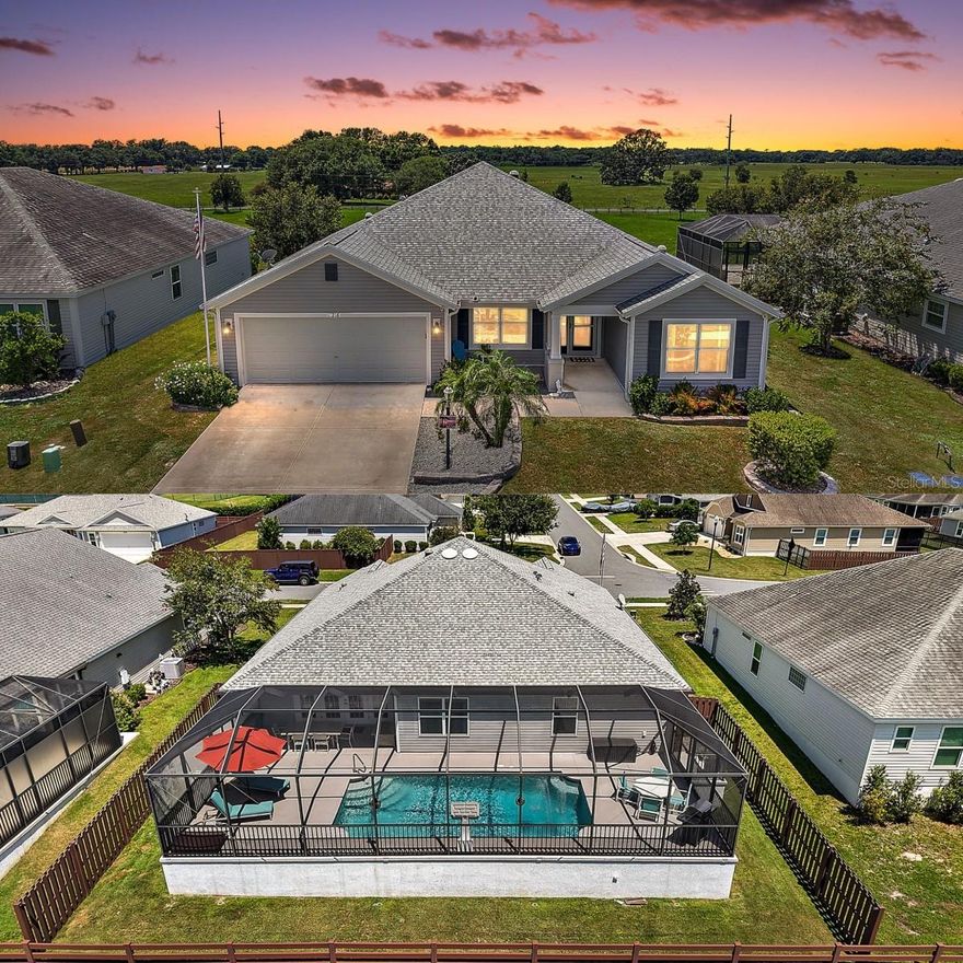 FABULOUS 4/2 Putnam Model with POOL on a PRIVATE, FENCED LOT overlooking a PRESERVE in the in the highly desirable, family-friendly, non-age-restricted, GATED community of Oxford Oaks! JUST MINUTES from The Villages retirement community, The Villages Charter Schools, and CR466 offering easy access to a plethora of shopping, dining, banking, medical and more! Tropical landscaping with curved TIERED walls and a charming FRONT PORCH welcome you in to the GENEROUS foyer of this BEAUTIFUL home! HIGH VAULTED ceilings and TILE flooring grace the VOLUMINOUS living, dining and kitchen areas. The OPEN-CONCEPT floor plan offers a SPACIOUS layout that connects these rooms for effortless entertaining and everyday living. From the living room, FRENCH DOORS open to the FABULOUS OUTDOOR OASIS of the lanai and POOL area overlooking PEACEFUL PRESERVE VIEWS! ENJOY your own PRIVATE HAVEN as you SWIM in the refreshing POOL; soak up the sun on the SPACIOUS deck; ENTERTAIN friends and family; or simply RELAX with your morning coffee, evening cocktail, or a good book! Doors at either end of the POOL area invite you to step outside to the PRIVATE, FENCED, REAR YARD – perfect for children - and the INVISIBLE FENCE is perfect for pets. Back Inside, the STUNNING GOURMET kitchen boasts GORGEOUS EBONY cabinetry, NEUTRAL countertops, STAINLESS appliances, EAT-IN breakfast bar,  built-in PANTRY, and a SOLAR TUBE. Retreat to the primary bedroom boasting LUXURY VINYL PLANK flooring, TRAY ceiling, and a WALK-IN closet.  It’s en-suite bathroom features EBONY cabinetry, NEUTRAL countertops, DOUBLE sinks, TILED ROMAN-STYLE WALK-IN shower, SEPARATE water closet, and a LINEN closet. A SPLIT floor plan, offers two additional bedrooms and a second bathroom conveniently hidden behind a POCKET DOOR near the front of the home, creating a PRIVATE guest wing. Bedrooms two and three each feature LUXURY VINYL PLANK flooring and built-in closets. The second bathroom is well-appointed with an EBONY vanity with NEUTRAL top, SOLAR TUBE, and a TILED tub and shower combination. There’s also a fourth bedroom with LUXURY VINYL PLANK floors and a built-in closet across the foyer. The INTERIOR LAUNDRY is centrally located just off of the kitchen and features EBONY cabinetry with NEUTRAL countertops, shelving, and a utility sink. Completing the package is a 22’x28’ two-car garage with PLENTY of room for parking and EXTRA STORAGE! With so much to offer, THIS HOME IS A MUST SEE! The Oxford Oaks Community offers INCREDIBLE AMENITIES including: a Resort Style Swimming Pool; Pickle Ball, Tennis, and  Basketball Courts; Outdoor Exercise Equipment; and a wonderful Children’s Playground! All for a LOW HOA payment of $55/month with NO ADDITIONAL FEES or BONDS! Conveniently located near the intersection of 466 and 301, Oxford Oaks is JUST MINUTES from The Villages retirement community, The Villages Charter Schools, and CR466 offering abundant shopping, dining, banking, medical, and more! DON’T MISS YOUR OPPORTUNITY TO MAKE THIS FANTASTIC POOL HOME IN AN AMAZING LOCATION YOUR OWN! Please watch our walkthrough video and call today to schedule your Private Showing or Virtual Tour!