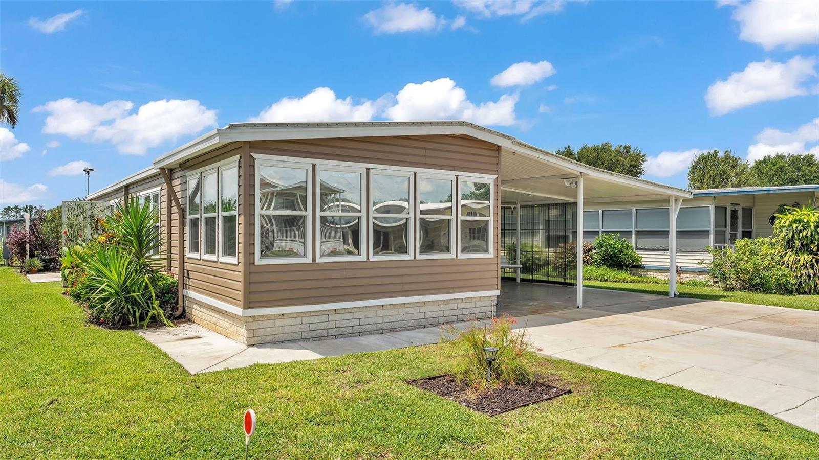 Welcome to this beautifully updated 2-bedroom, 2-bath home with a bonus room and Florida room, located in the desirable 55+ Tippecanoe Village community – where you own the land. Featuring luxury vinyl plank flooring (2023) and insulated, double-pane updated windows (around 2019) throughout, this home blends comfort with modern style. The exterior was painted in 2024, and the interior in 2023. Both bedrooms feature walk-in closets for ample storage. The front bonus room, formerly a porch, has been thoughtfully finished with central A/C, quality windows, and updated flooring, creating a seamless extension of the living space – perfect as a den, sitting area, home office, or hobby room. The inviting Florida room adds even more versatility, while a spacious 15' x 12' workshop and large 15' x 35' covered back patio provide excellent space for projects, entertaining, or relaxing outdoors. A carport adds even more convenience. HOA fee includes water, sewer, and trash, and residents enjoy access to community amenities such as a pool, shuffleboard courts, library, and social events. Enjoy the convenience of a great location with an easy commute to Tampa, Wesley Chapel, Orlando, and Lakeland – making this the perfect place to call home in Central Florida!