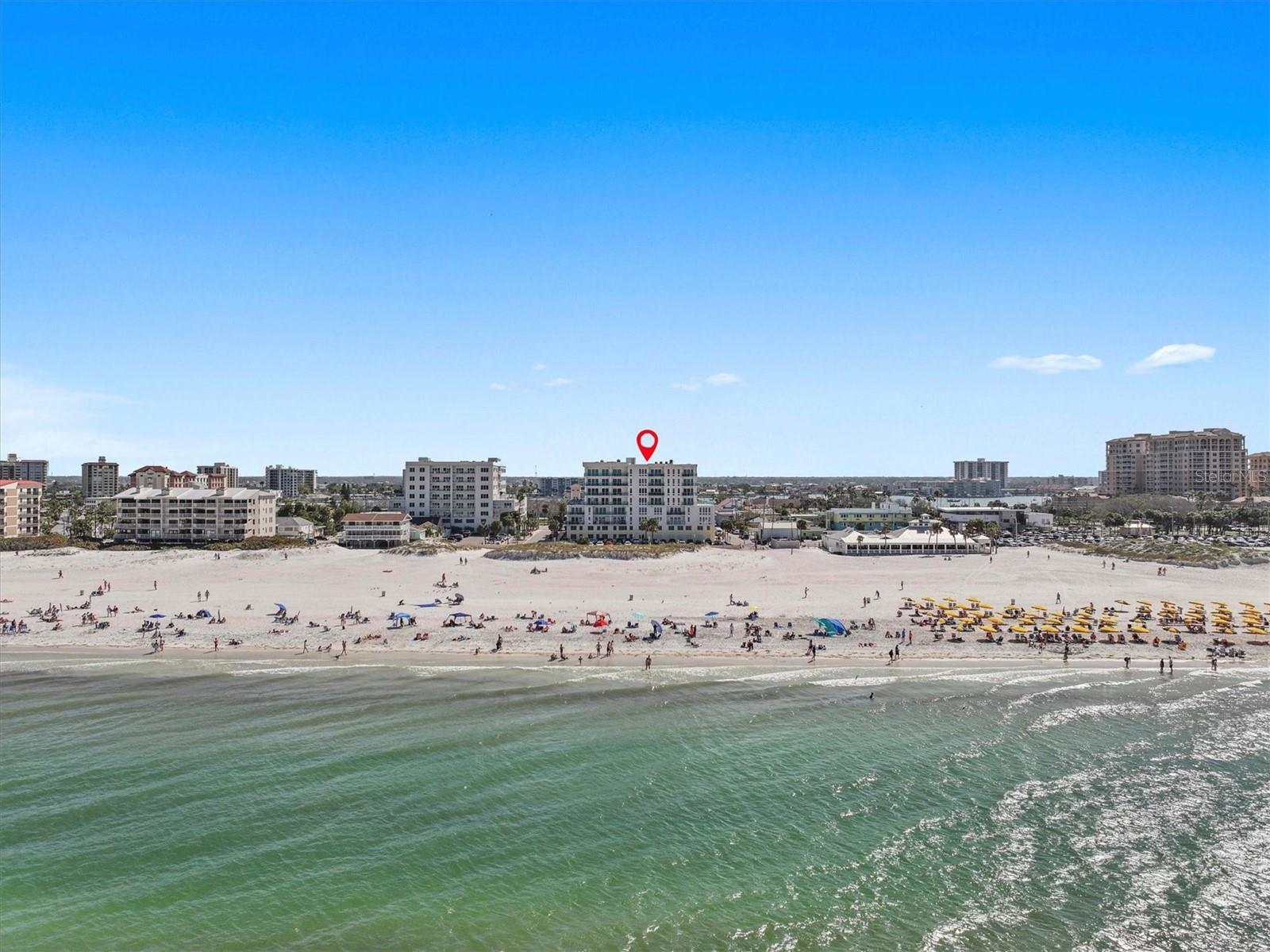 Experience the ultimate in luxury beachfront living at Pura Vida Clearwater Beach, where sophistication blends seamlessly with elegance. This exceptional 2,240-square-foot condominium features two bedrooms, a bonus room, an office, and two and a half bathrooms, designed with an open-concept layout that invites natural light and maximizes ocean views. The living, dining, and kitchen areas flow effortlessly into private glass-paneled balconies, providing the perfect setting for both entertaining and everyday relaxation. A harmonious mix of modern and traditional furnishings creates a transitional aesthetic that exudes livable luxury, while custom finishes and designer fixtures by Franco A. Pasquale Design Associates elevate the home's refined ambiance. The chef-inspired gourmet kitchen is a masterpiece, featuring top-of-the-line Miele and Sub-Zero appliances, sleek quartz countertops, custom cabinetry, a wine fridge, a gas stovetop, and a discreetly integrated dishwasher and refrigerator. The centerpiece is a striking waterfall quartz island with integrated deep sink, ideal for preparing meals while enjoying sweeping oceanfront views. After dinner, the primary bedroom provides a serene retreat with generous proportions, floor-to-ceiling windows, and a private balcony which is perfect for sunset gazing. Its en-suite spa-like bathroom boasts dual sinks, a separate water closet, a dedicated vanity, a soaking tub, and a glass-enclosed shower, all enhanced by a luxurious towel warmer. The walk-in closet is nothing short of a boutique-inspired haven, complete with illuminated wardrobe, chandelier, spacious jewelry cabinet, and a hidden washer and dryer with water filtration system, for ultimate convenience. For your out-of-town guests, the guest bedroom offers privacy and comfort with ocean views and its own en-suite bathroom. The oversized walk-in closet has been thoughtfully reimagined into a charming sleeping nook, featuring bunk beds and a custom mural of Clearwater Beach, ensuring every guest has a memorable stay. This property offers secure, gated access with two designated parking spaces that pre-wired for charging stations. A secure private elevator opens directly into the foyer, with an additional secure entry for added peace of mind. Practical features include a bike storage room, a designated beach locker, and a spacious air-conditioned storage unit. Situated in the heart of Clearwater Beach, this prime location offers easy access to pristine sands, vibrant dining experiences, boutique shopping, and recreational activities such as pickleball and a nearby playground. After a day exploring the best of Florida's renowned coastline, unwind by the oversized heated pool and spa, stay active in the well-appointed fitness center, or gather with friends in the inviting club room. Combining luxurious design, thoughtful functionality, and a prime beachfront location, this exceptional property is the ultimate coastal retreat. Contact us today to schedule your private showing and discover the unparalleled lifestyle awaiting you at Pura Vida Clearwater Beach.