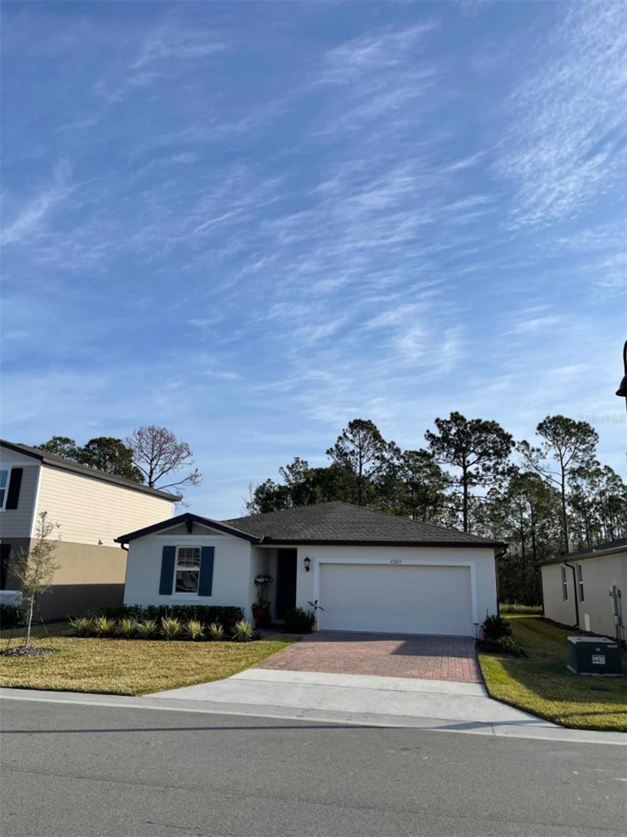 This energy-efficient, one-story home offers 1988 sq ft of living space with 4 bedrooms and 3 bathrooms, designed to help you save on utility bills. It features a spacious kitchen that flows into an adjoining dining area and a great room, all with an open concept. You can also enjoy the screened lanai, which overlooks a large backyard with nature conservation views.
The home is located in a nice, quiet, and gated community that includes a pool, playground, and covered picnic area. Its location in Four Corners is incredibly convenient, situated off SR 192 and US 27, and just a few miles from 429. This provides an easy commute to the heart of the Orlando Market, including Disney World, Universal Studios, and downtown Orlando. You'll also find Lowes, Walmart, Publix, Aldi, and many restaurants and retailers nearby. Additionally, the new public elementary and middle school, Lake Pointe Academy (K-8), is only 1.1 miles away.