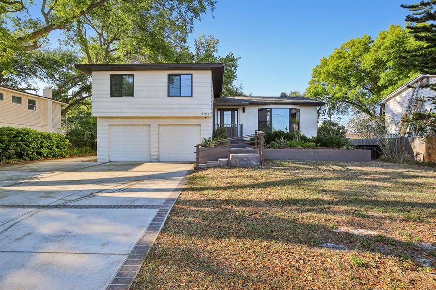 One or more photo(s) has been virtually staged. Looking for something with character? This distinctive three-level home delivers a rare Florida find with a basement level that opens up endless possibilities. The main living space features a bright and inviting layout with a kitchen that offers lots of storage, stainless steel appliances, a center island & beautiful countertops.  The comfortable living room has a bay window adding architectural charm. The lower level is a standout, offering a cool, multi-use space with a fireplace and bar area—ideal for entertaining, a lounge, or creative flex space. There is also a bedroom and bathroom on this level that is ideal for in-laws or long term guests. Upstairs, the oversized primary suite provides a comfortable retreat, and there's also two additional bedrooms and a bathroom.  The utility room is conveniently located on this level. A home that blends personality, function, and versatility in all the right ways.  The location is top notch with Gulf Beaches, Botanical Gardens, & Lake Seminole all just 10 minutes away!  This home is a must see!