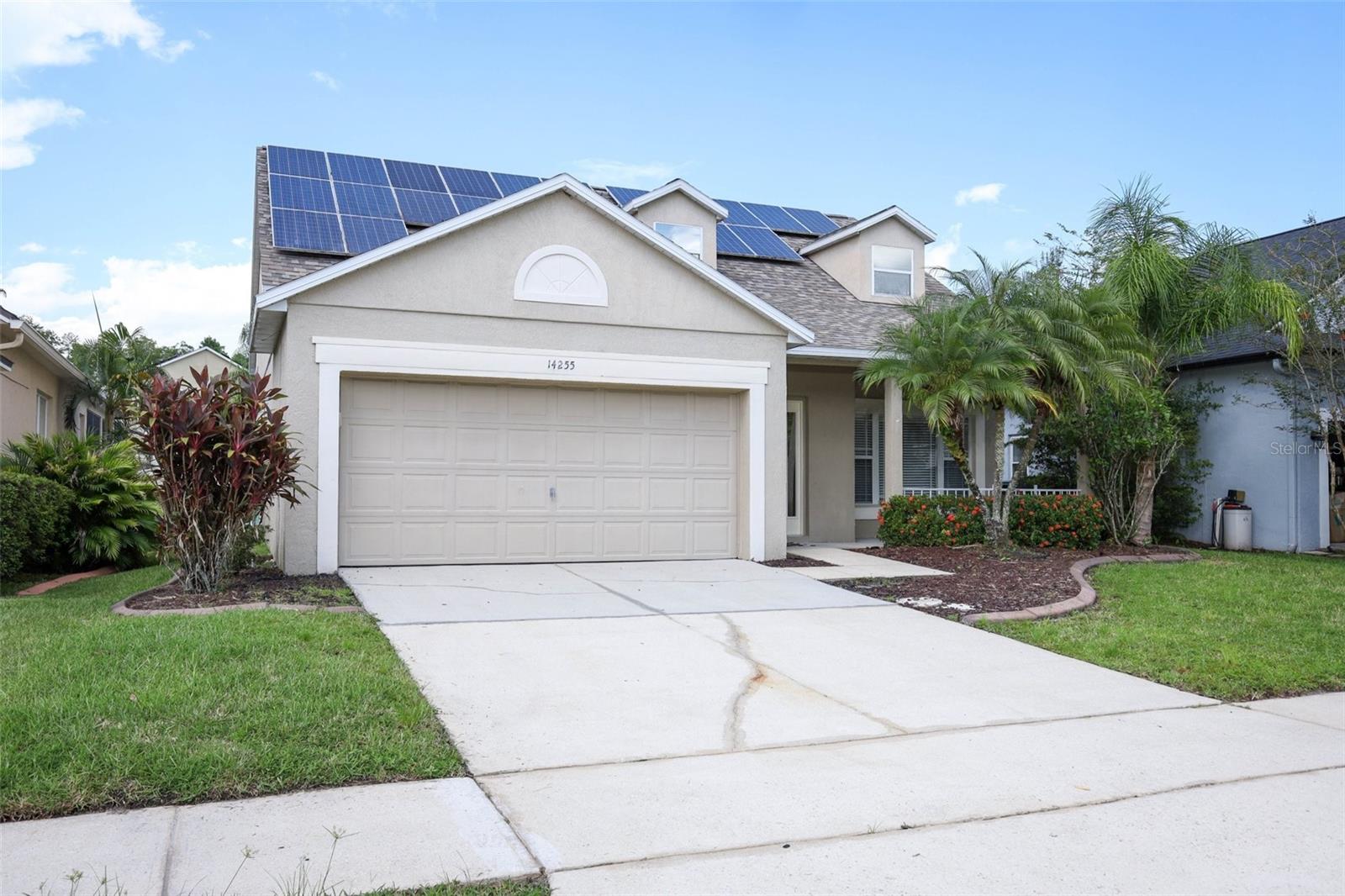 One or more photo(s) has been virtually staged. Welcome to 14255 Squirrel Run, a beautifully upgraded home located in the Glenwood Run village of the man-gated, golf course community of Stoneybrook East in desirable East Orlando. This thoughtfully designed residence offers comfort and functionality from the inside out. A charming front porch leads you into the open-concept living space where the kitchen serves as the heart of the home, featuring a center prep island, pendant lighting, dining counter, beverage cooler, and direct slider access to the covered lanai and screen-enclosed pool—perfect for indoor-outdoor entertaining. The first floor includes a spacious primary retreat, a convenient half bath, and laundry room for added ease of daily living. Recent updates include new luxury vinyl plank flooring throughout the main level living areas, new carpet on the stairs and second floor. Upstairs you’ll find all secondary bedrooms along with a flexible open loft area, ideal for a home office, playroom, or media space. The fenced rear yard offers additional privacy, and the owned whole-house solar system provides significant energy efficiency. Stoneybrook East is a premier 24-hour man-gated community offering residents access to a junior Olympic-size pool, clubhouse, fitness center, tennis, basketball, and pickleball courts, playgrounds, and walking trails—all within a meticulously maintained setting. Ideally situated in East Orlando, the home is just minutes from Waterford Lakes Town Center, Avalon Park, the University of Central Florida, and major commuter routes including 408, 417, and 528. Highly rated public schools, abundant shopping and dining options, entertainment venues, and a wide range of extracurricular activities make this an exceptional opportunity to enjoy a balanced and vibrant Florida lifestyle. Schedule your private tour today!