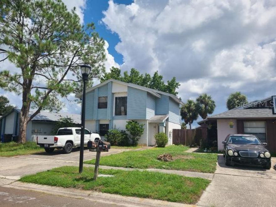 Lowest priced single family home in the entire Carrollwood area by over 125k! 3/2.5 with water view. The house has damage from water intrusion and will need MAJOR rehab including a full trash out. No HOA approval required and low monthly fees of $79. Community pool, tennis and basketball courts and more. Great location near major roads, shopping, and dining. Sold AS-IS. Cash only. All inspections must be done prior to offering. Room measurements are approximate. Please verify if important.