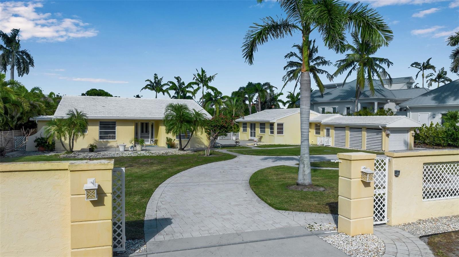 Just steps from the sugar-sand beaches of Lido Key and a short stroll to the boutiques and restaurants of St. Armands Circle, this classic coastal property offers the best of Sarasota’s island lifestyle. Perfectly positioned on a 16,971 sq. ft. lot with 98.5 feet of canal frontage, the home captures cooling Gulf breezes and an effortless connection between indoor and outdoor living. The three-bedroom, three-bath main residence features light-filled living spaces, easy-care block construction, and thoughtful updates that blend comfort with coastal charm. An inviting one-bedroom, one-bath guest house—complete with its own kitchen, bath, and private entrance—provides the ideal retreat for visitors or extended family. Outdoors, a dock with lift and a well-maintained seawall make boating and waterfront enjoyment a breeze, while the property’s lush yet low-maintenance landscape enhances its relaxed island setting. With immediate access to the beach, serene canal views, and proximity to Sarasota’s vibrant cultural and dining scene, 369 South Polk Drive is an exceptional opportunity to own a piece of paradise on Lido Key.