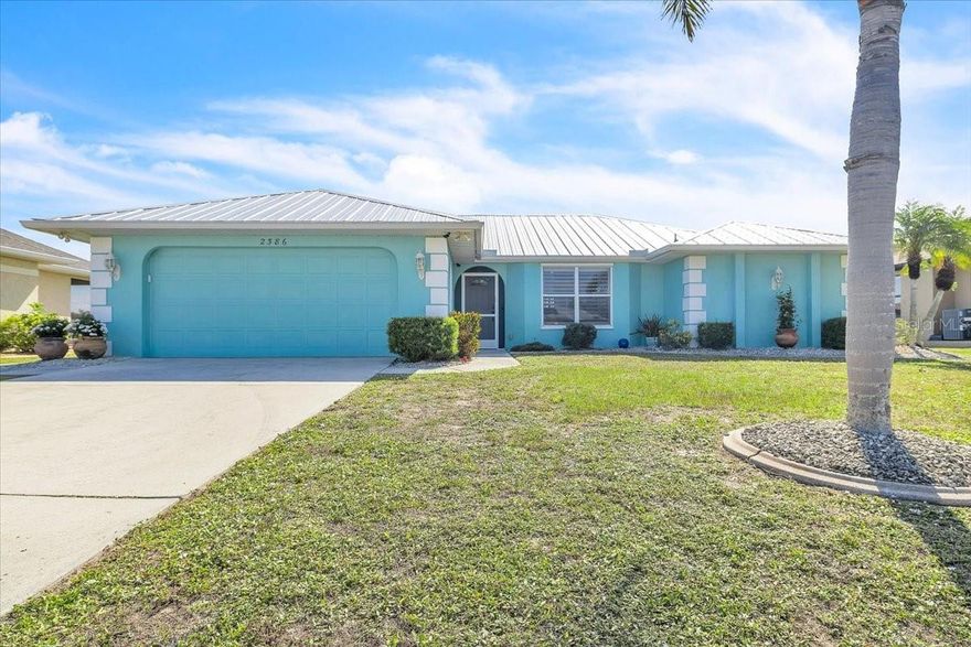 Meticulously maintained home on a cul-de-sac street located in the much sought after deed restricted community of Deep Creek, offering public water, public sewer, and a reasonable annual HOA fee. NOT in the Flood Zone. Open kitchen so you don't miss out on anything going on when entertaining. Kitchen offers newer range and refrigerator, Bosch dishwasher, closet pantry, cabinetry with pull out drawers and breakfast bar. Dining area overlooks the back yard and lake. Spacious living room with a four-panel pocket sliding door to the covered and screened lanai with a lake view. Primary bedroom has a French door for private access to the lanai, en-suite bathroom with a walk-in shower, makeup vanity, and two walk-in closets. Split bedroom plan with a pocket door for additional privacy to bedrooms 2 and 3. Plantation shutters on windows, neutral tile flooring in the main living area and carpeted bedrooms. Interior laundry with laundry sink, cabinets, and includes the washer and dryer. Peace of mind hurricane panels are ready when you need them.  April 2025 - New garage door opener. February 2023 - Changeout to a new Ruud A/C system. November 2022 - New Metal Roof. April 2022 - Re-piped water lines inside home. Deep Creek is a deed restricted community that sits north of the Peace River offering biking and walking pathways, and spacious greenbelt space between properties. For the past 3 years home has been used as a high-end winter rental. Just a 15-minute drive to the Punta Gorda Airport (PGD). Golf, parks, restaurants, schools, medical, churches and shopping are all nearby. A short distance to I-75 at exit 167 or 170 affords easy access to historic downtown Punta Gorda/Fort Myers/Naples to the south and North Port/Venice/Sarasota to the north. Only 2 miles to Deep Creek Golf Club, open to the public.