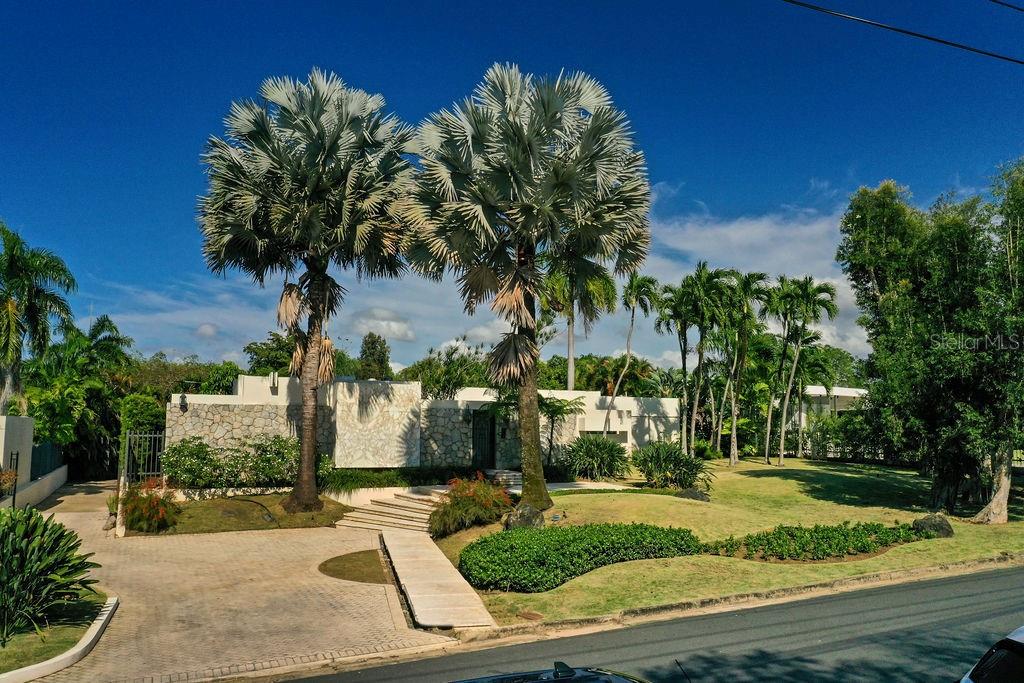 Elegant estate nestled on the coveted Orquidea Street in Santa María, this home offers refined living surrounded by lush landscaping and spacious interiors. This exceptional residence provides expansive, thoughtfully designed spaces on a beautifully landscaped lot of approximately 4,362.16 square meters.
The main living area is arranged on a single level, beginning with a tropical garden entrance that leads into a grand living room with seamless access to the patio. Adjacent is an ensuite guest room, perfect for visitors or as a private office.
The formal dining room opens to its own intimate patio, followed by a bright, large kitchen with generous storage, laundry room, and a utility room with ensuite bathroom for added convenience.
The bedroom wing features four spacious bedrooms and a comfortable family room. Two bedrooms share a large bathroom, while a junior suite includes an office nook. The primary bedroom suite overlooks the pool and patio, offering a peaceful retreat.
On the lower level is a versatile open-concept space currently used as a game room, complete with its own kitchen and two full bathrooms. This area could easily be converted into a separate guest suite.
Outdoors, the front yard welcomes you with manicured gardens and a stately entrance. In the backyard, a semi-Olympic pool with four swim lanes offers a swimmer’s dream setup, ideal for both recreation and exercise.
The home offers an impressive 6,202.70 square feet of interior living space, plus an additional 2,318.40 square feet of terrace, porch, garage, and storage, for a total of approximately 8,521.10 square feet under roof.
With 4 bedrooms, 1 guest room, 1 utility room, 7 full bathrooms, 1 half bathroom, and a 3-car garage, this remarkable property delivers both comfort and grandeur.
Now available for sale for the first time, schedule your private tour today!