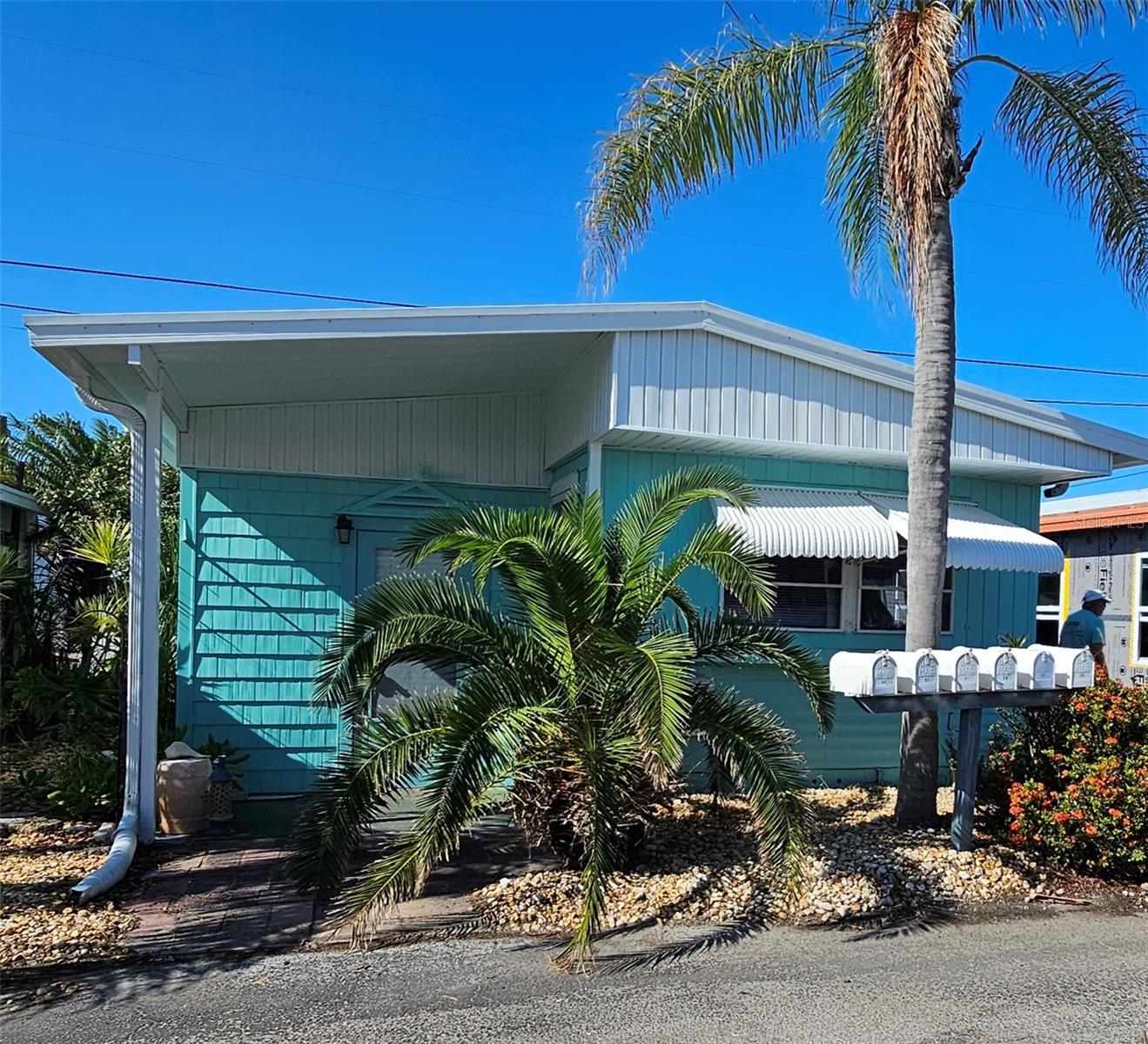 Welcome to Paradise Bay Estates where location truly means opportunity. 1BR/1BA mobile home is nestled in a desirable +55 waterfront community. Home suffered interior damage from 2024 storms, but is now ready and awaits your creativity. While Hurricane Helene left her mark with flood waters, the exterior has already received a fresh coat of paint in November of 2024. The interior is a blank slate waiting for someone to come in and do a complete remodel. This is your chance to restore and personalize this home, bringing it back to better-than-new-beauty. The park offers an full slate of activities with an active clubhouse, pool, woodworking shop, shuffleboard etc. This community is less than a 2 mile walk, bike, drive or boat ride to Anna Maria Island. Discover the value in this much sought after location. Come see how this project can become your perfect coastal retreat!