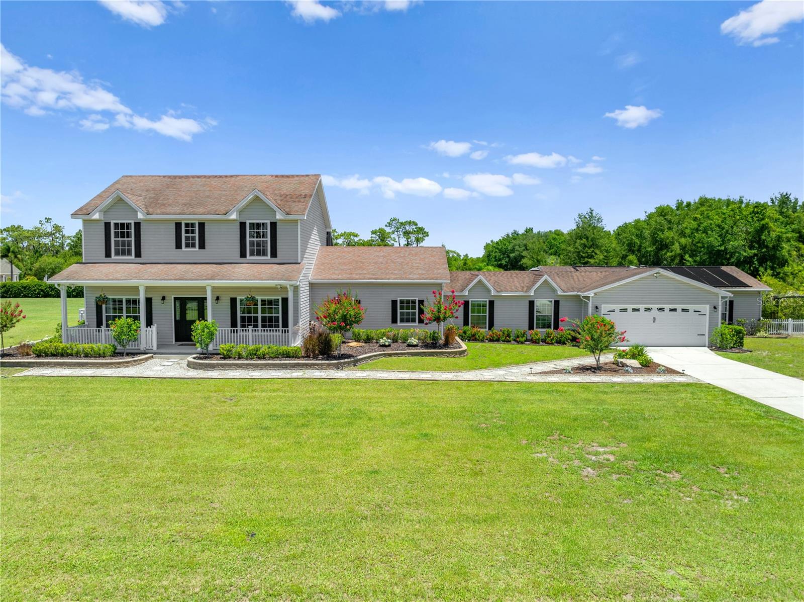 WELCOME TO THIS EXCEPTIONAL TWO-STORY ESTATE, OFFERING THE PERFECT BLEND OF PRIVACY, SPACE, AND STYLE ON 2.35 FULLY FENCED ACRES WITH AN ELECTRONIC GATE FOR ADDED SECURITY AND CONVENIENCE. THIS 4-BEDROOM, 4-BATHROOM HOME IS THOUGHTFULLY DESIGNED TO SUPPORT BOTH EVERYDAY LIVING AND ENTERTAINING ON A GRAND SCALE. THE HEART OF THE HOME IS A BEAUTIFULLY APPOINTED KITCHEN, FEATURING RICH WOOD CABINETS, GRANITE COUNTERTOPS, A STYLISH GLASS TILE BACKSPLASH, UPDATED APPLIANCES, AND A BUILT-IN BEVERAGE/ WINE COOLER. A LARGE CENTRAL ISLAND ANCHORS THE SPACE, SEAMLESSLY OPENING TO THE EXPANSIVE LIVING AND DINING AREAS—IDEAL FOR GATHERING WITH FAMILY AND FRIENDS.
BEYOND THE MAIN LIVING AREAS, A SPACIOUS FAMILY ROOM OFFERS ENDLESS POSSIBILITIES FOR RELAXING OR HOSTING, WHILE A FLEXIBLE BONUS ROOM—PERFECT AS A GYM/OFFICE OR FLEX SPACE— IT HAS ITS OWN REFRIGERATOR HOOK UP, SINK, AND INSIDE WASHER AND DRYER HOOK UP. THE HOME ALSO INCLUDES A SPACIOUS 4-CAR GARAGE, A DEDICATED WORKSHOP, AND ADDITIONAL STORAGE, COMPLETE WITH A SECOND LAUNDRY AREA AND REFRIGERATOR HOOK UP TO MEET ALL YOUR PRACTICAL NEEDS. STEP OUTSIDE AND BE TRANSPORTED TO YOUR OWN PRIVATE OASIS. THE SCREENED-IN POOL AREA WITH ELEGANT PAVERS AND AN OUTDOOR KITCHEN IS PERFECT FOR FLORIDA LIVING, WHILE YOU UNWIND BENEATH THE STARS. FOR GARDENING ENTHUSIASTS, FOUR LARGE RAISED PLANTERS WITH FULL IRRIGATION AND PLANTING TABLE WITH SINK ARE READY FOR PLANTING. AN OVERSIZED METAL CARPORT PROVIDES AMPLE SPACE FOR BOATS, RVS, OR RECREATIONAL TOYS. THIS PROPERTY OFFERS ROOM TO BREATHE, ROOM TO GROW, AND ROOM TO ENJOY EVERY MOMENT. WITH ITS BLEND OF THOUGHTFUL AMENITIES AND SPRAWLING OUTDOOR SPACE, IT'S THE PERFECT PLACE TO CALL HOME. CLOSE ENOUGH TO DINING, SHOPPING, SCHOOLS AND THE FLORIDA TURNPIKE TO GET TO ANYWHERE IN CENTRAL FLORIDA. SOLAR PANELS FOR HEATING THE POOL. 350 GALLON UNDERGROUND PROPANE TANK THAT SERVICES GAS COOKTOP, WATER HEATER, & BBQ. SEPTIC SERVICED AND PUMPED 2025. UPDATES LAST 5-6 YEARS... NEW WATER SOFTNER PUMP 2025, NEW AC 2024, NEW DISHWASHER 2024, UPSTAIRS JACK & JILL BATHROOM REMODELED, NEW SMART BUILT OVEN AND MICROWAVE 2023, NEW FLOORING (CERAMIC TILE) 2021, RE SCREEN POOL ENCLOSURE 2021, STEEL CARPORT 2020, NEW WELL 2019.