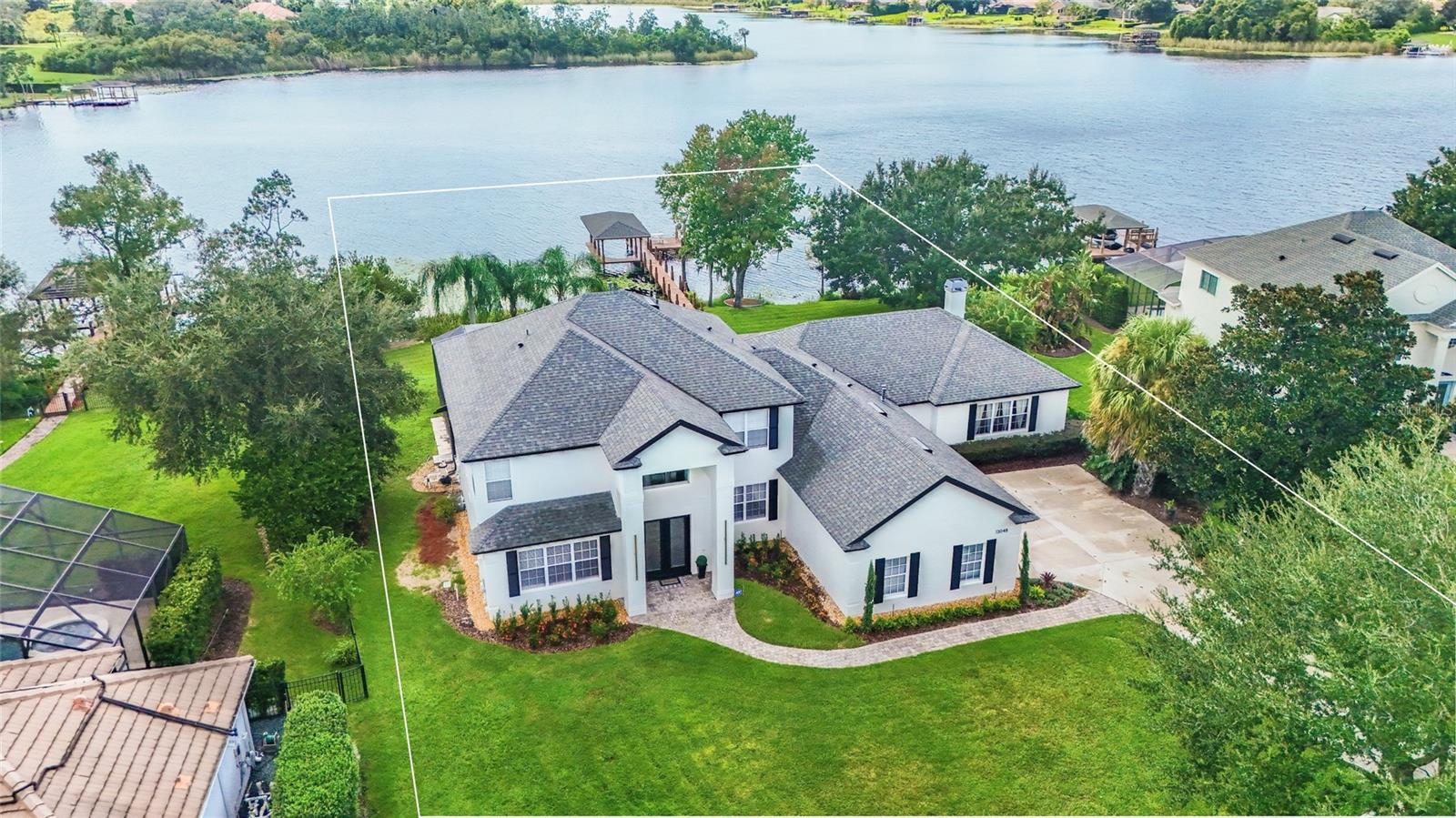 Enjoy the e evenings to a breathtaking sunset at your own private lake in this stunning custom-built home.
Land: 1.6 acres including lake portion with 135 feet direct lake frontage. Lake Roper is renowned for its water sports, water skiing, jet skiing and fishing only acceded by the surrounding houses (No Public Ramps). This is one of the largest lots in the community.
Location: Only minutes from Winter Garden Village and Downtown Windermere, minutes from main roads like 429 and 408 and a short distance from Theme Parks and Shopping Areas. Great School District.
Kitchen: Totally renewed, custom-built cabinetry, high-end stainless still appliances, built in induction cook top, built in microwave and oven, huge island built with one piece of quartz, no sims. Pop-out outlets, touchless faucet and built in hood.
Bathrooms: Contemporary look with porcelain tiles, quartz tops, custom made cabinetry and modern metals.
Pool area: The pool was resurfaced, surrounded by new pavers overviewing the lake and a brand-new equipped summer kitchen just built.
Dock: Wood dock and fishing pier with Eletric Boat lift.
The house was completely renovated from top to bottom including new engineering hardwood floors, 3 new A/Cs, new water heater, new irrigation system, fresh painted and new roof installed in 2020.
