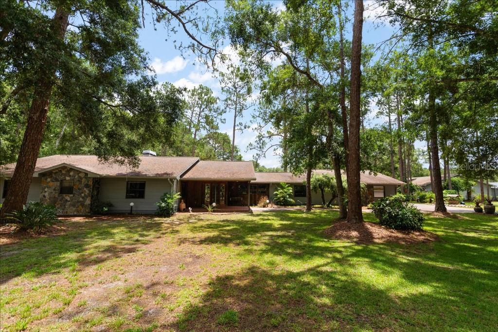 RARE Find!! 5.11 Acre Property located in the heart of north Pinellas in Keystone Ranchettes. No HOA or DEED RESTRICTIONS. Horses & Livestock welcome. Private horse trails for Keystone Ranchettes residence only via Ranch Rd to Brooker Creek Equestrian Track. Imagine an exceptional opportunity to blend your passion for equestrian pursuits & country living within beautiful Tarpon Springs no need to trailer your horses just ride out of your barn to the multiple trails nearby. Drive through the majestic Pines follow to your stunning rural haven nestled in a tranquil setting with a peaceful pond and pasture nestled along Brooker Creek Preserve. This extraordinary custom 4 bedroom, 2.5 bathrooms, with oversized 2 car garage. The estate offers the perfect blend of refined country living. Complete with a bonus workshop and stable. Upon entering this home, you’ll be greeted by the grandeur of vaulted ceiling in the large livingroom , a cozy fireplace, elegant travertine flooring, pecky cypress details all designed to frame breathtaking views of the serene pond. The private primary suite with , full bathroom with double sinks and Jacuzzi tub, walk-in closet, and fireplace step out to your expansive screened porch and take advantage of the beautiful view of the pond and pasture. On the opposite wing, the kitchen is a chef's dream with plenty of storage and granite countertops. It boasts a stunning combination of Travertine floors and granite countertops, custom cabinetry and lighting and induction stove. The kitchen also features a custom built pecky cypress pantry. Off the kitchen is the dining room with beautiful views of the pond and pasture a half bathroom and nice sized laundry room with additional office/ hair salon. . The large screened in porch with outdoor kitchen extends the length of the home to take advantage of the views of the pond and wooded areas. This space offers unparalleled views of the tranquil pond, making it perfect for relaxation or entertaining. The outdoor features are just as impressive. A large workshop with attached stables. This presents endless possibilities as a retreat, man/woman cave, or even its original purpose. Equestrians will enjoy the proximity to a nearby nature preserve featuring nearly 5 miles of scenic riding trails. This exceptional estate offers a unique lifestyle that seamlessly combines luxurious living with outdoor adventure, creating the ultimate private sanctuary. Convenient to Tampa, both Airports,Sunset Beach, shopping, and all Tampa Bay has to offer!