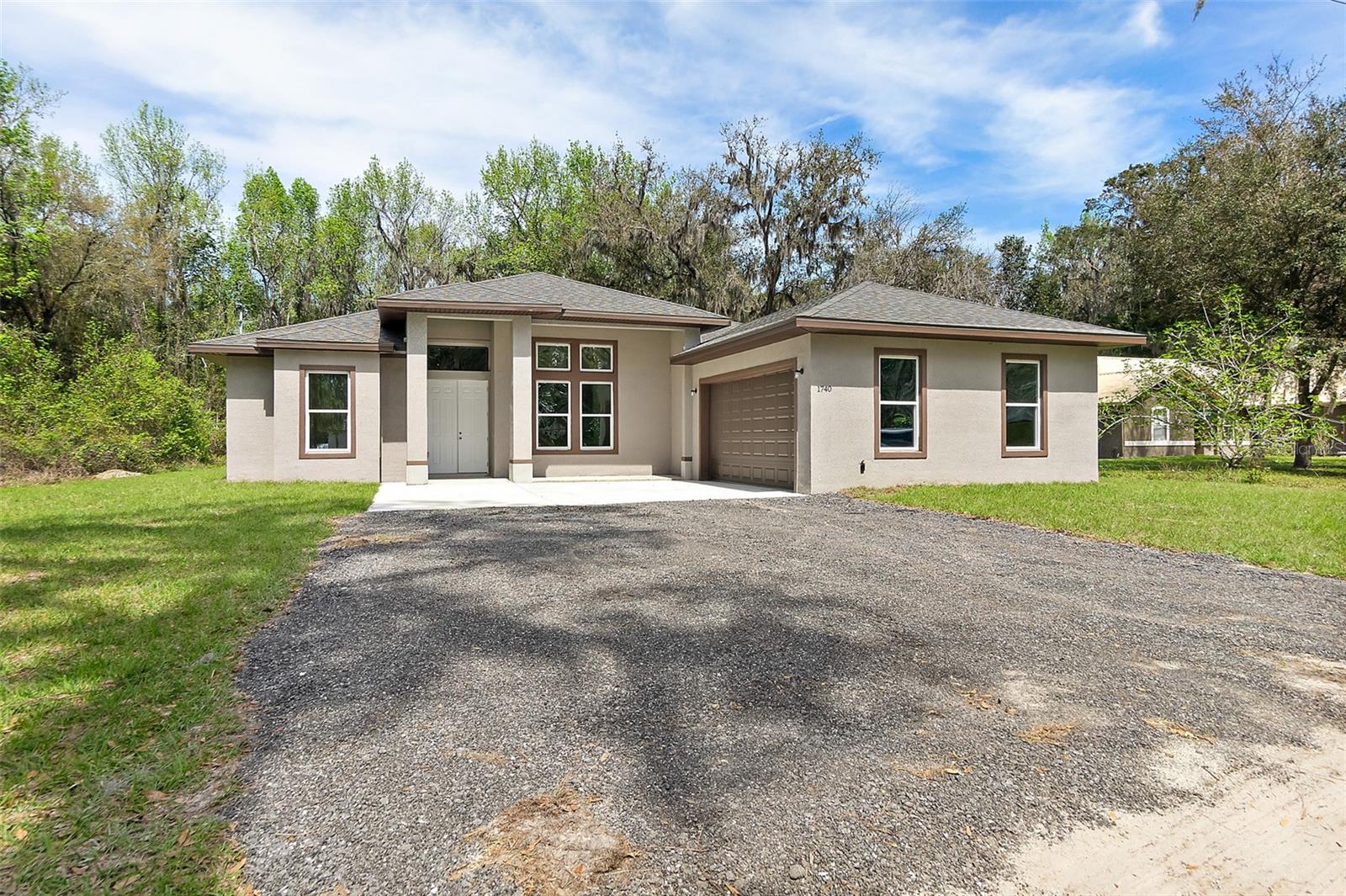 Across St. Johns River. It has Exterior vented hood, all 8 ' doors, double doors in front. The baths have floor to ceiling tile. Sprayed foam insulated. peaceful cul-de-sac . This 3-bedroom, 2-bathroom home boasts an open/split floor plan, accentuated by soaring 14' ceilings in the living room and 10' ceilings in the bedrooms. Big Laundry Room. Exceptional garage: 8' door 2.5 car garage . NO HOA. Almost 1 acre !