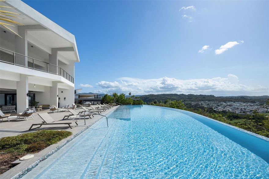 Modern Elegance @ Monte Azul, Guaynabo
A master-planned community with unique spaces, luxuries, and amenities for the modern family. This modern two-story residence with 2529 sqft sits atop Guaynabo’s exclusive new development Monte Azul. Featuring spacious open interiors with 4 bedrooms, 2.5 bathrooms, a double garage, open-layout floorplan in the living and dining areas.  Modern kitchen with Quartz countertops, KitchenAid appliances, a laundry room, impact-resistant aluminum doors and windows. This home seamlessly blends indoor and outdoor living. Professionally decorated,all high-end furnishings included. This gated community offers 24/7 security, visitor parking, and amenities including a clubhouse, infinity pool, gym, tennis, pickleball and basketball courts, beach tennis, and a children’s playground. Enjoy a private, safe and quiet environment designed for your well-being. HOA $425.