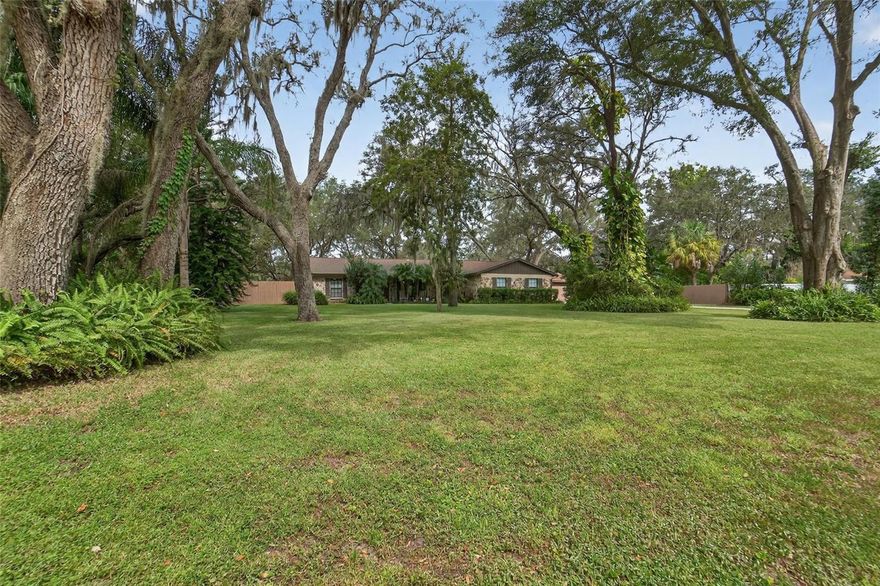 Under contract-accepting backup offers. YOUR MARVELOUS MAGNET FOR FAMILY & FRIENDS IS HERE! This property offers so much more than the house alone! On a privacy-fenced, tree-shaded acre in Riverview’s Shadow Run, this 1,865-SF home with 3 bedrooms/2 baths has been expanded by a 285-SF Florida room, 500-SF game room with bar, 1,000-SF barn with 4 garage bays & a workshop/craft room, screened lanai with outdoor kitchen, gated pet yard with kennel, secluded firepit patio -- plus a gorgeous, saltwater, heated pool with no-step ‘beach entry’ in a big, stone-pavered deck that includes screened & roof-sheltered sections for all-weather enjoyment. WOW! Lighted, pavered paths connect it all, & there's so much space for parking on the extended, expanded driveway as well as the yard behind a 12-foot-wide, electric-powered gate that you'll be where everyone loves to gather. The record of improvements here is even longer than the list of amenities, with HVAC at the top because 1 owner is a heating & cooling professional who has updated ductwork & equipment everywhere. Almost every room features double-pane, storm-impact windows; water is treated with a whole-house reverse-osmosis system; the well has a recently installed submersible pump of 1 HP. Inside you'll find granite, wood, tile & luxury vinyl plank floors, decorator lights & fixtures, a fieldstone fireplace focal point in the living room, & extensive upgrades to both bathrooms as well as the kitchen. The kitchen is really something special, nearly doubled in size so its stainless-steel appliances include both a French-door fridge with icemaker & a fridge-size freezer, built-in convection oven in addition to the convection range & microwave, dishwasher, disposer, undermount sink in 1 area plus a farmhouse sink in the other, all beside an oversized laundry room with cabinets above & below 2 countertop segments. (If that's somehow not enough, by the way, you'll find a smaller version of the granite-&-stainless kitchen outside past the pool in the barn's screened lanai!) Last but very far from least, there's the truly impressive pool lanai itself, where these owners spared little expense creating their backyard oasis a decade ago. Today it boasts a Hayward titanium electric heater, variable speed pump, diatomaceous-earth filter, & an extra waterfall feature. Are there details we haven't covered yet? Yes! But that's why you want to schedule your personal tour today so you can act quickly to make this yours!