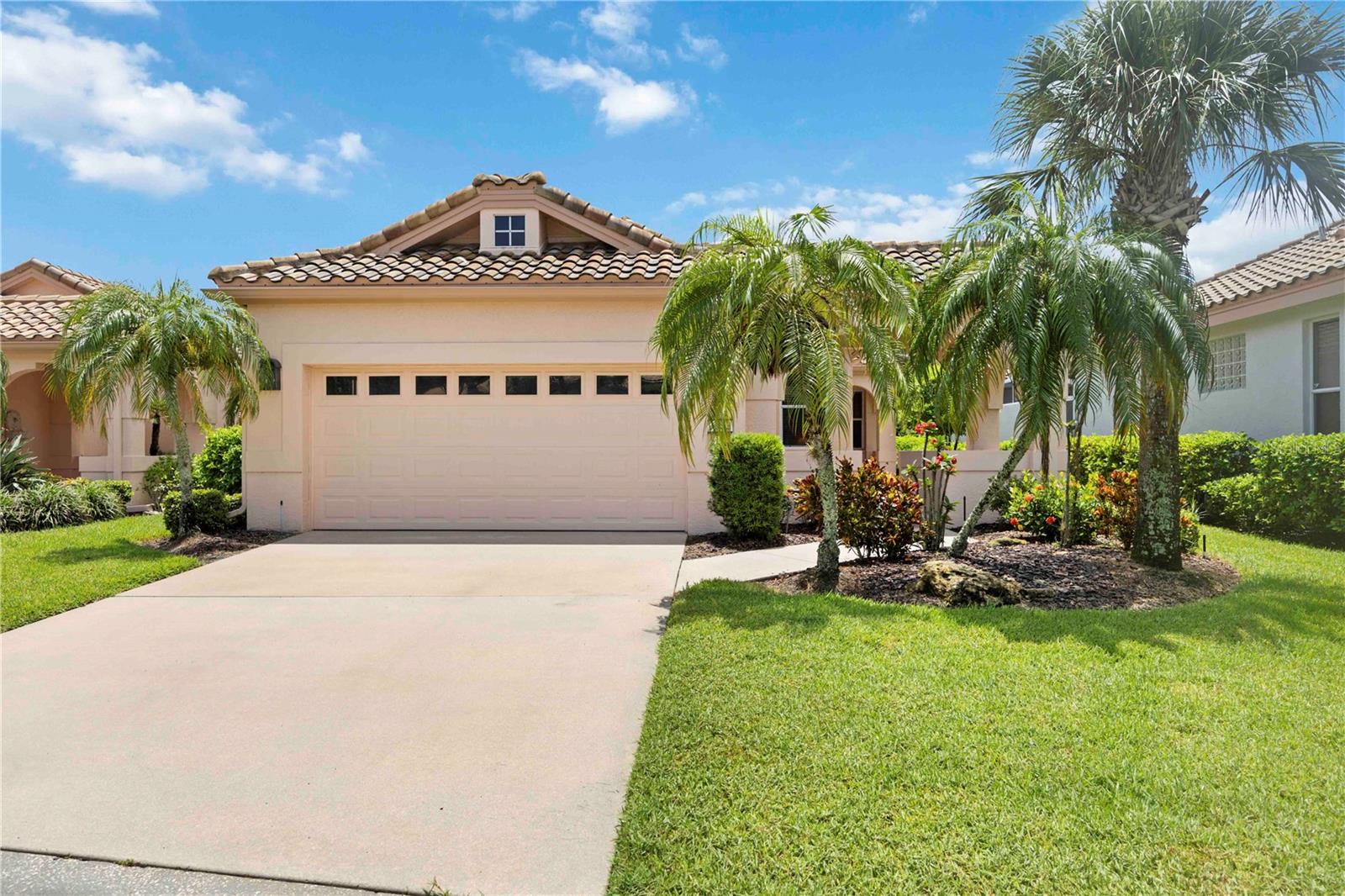 Discover the perfect blend of comfort, space, and low-maintenance living at 3852 Amapola Lane—an impeccably cared for, one-owner home tucked inside a gated, pet-friendly community known for its scenic lakes, winding sidewalks, and resort-style heated pool and spa. From the moment you step onto the charming brick entry patio and through the glass-accented front door, you’ll notice the thoughtful touches: soaring ceilings, elegant crown molding, and tile floors laid on the diagonal. The heart of the home is a spacious eat-in kitchen with Corian countertops, recessed lighting, a large pantry, and plenty of room to gather. The open-concept living and dining area offers easy flow into an air-conditioned Florida room and out to the freshly screened lanai with an elevated cage—perfect for enjoying Florida’s indoor-outdoor lifestyle. The expanded primary suite is a private retreat, boasting double custom walk-in closets and a spacious bath with dual vanities, a walk-in shower, and enclosed water closet. Guests will appreciate the tucked-away second bedroom and full bath, set apart by a pocket door for added privacy. A cozy den with ceiling height built-in bookcases makes an ideal office or flex space. The home also features a convenient laundry room with sink and cabinetry, hurricane sliders, protective film on all other windows, and a spacious 2-car garage with built-in workbench. HOA covers lawn care, roof and sidewalk cleaning, and more—so you can spend your time enjoying the good life. All information provided by the sellers is deemed reliable but is not guaranteed. Buyers are encouraged to verify all information independently.