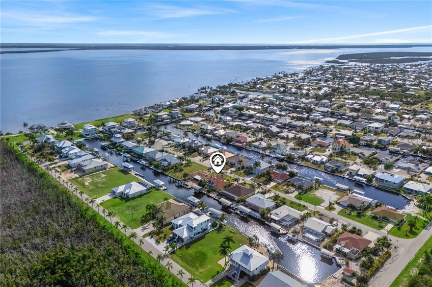 NO FLOODING! LIVE THE DREAM WITH MINUTES OUT TO OPEN WATERS! Welcome to your dream waterfront home in beautiful St. James City! This fully remodeled 4-bedroom, 4-bath residence offers unparalleled luxury and comfort. Nestled on a direct access canal, a true boater's paradise with a 10,000-pound boat lift, just a few minutes to some of the best fishing, boating and islands in SWFL! As you step inside, you'll be greeted by a massive vaulted ceiling that is light and bright - a modern, open-concept living space with a dream kitchen high-end stainless-steel appliances, sleek ceramic flooring, and stunning quartz countertops. Open to the living area and beautiful views from the window. The layout is thoughtfully designed with two master suites on the ground floor, each boasting en-suite bathrooms, perfect for multi-generational living or hosting guests. Upstairs, you'll find two generously sized bedrooms, one of which opens to a private balcony, offering serene views of the canal and the surrounding area. Step outside to your personal oasis where a sparkling pool and spa await, ideal for relaxing and entertaining. Whether you're lounging by the pool or enjoying a sunset cruise from your private dock, this home offers the ultimate Florida lifestyle. Don't miss the opportunity to own this exceptional property in St. James City. Schedule your private tour today and experience waterfront living at its finest! All the work has been done, just move right in!