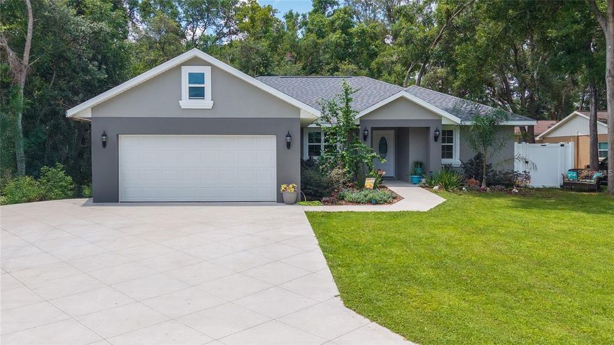 WHY BUILD WHEN YOU CAN PURCHASE THIS LIKE NEW HOME! 2023 CUSTOM BUILD 3 BED/2 BATH HOME - NO HOA SO BRING YOUR TOYS  -PRIME VILLAGE LOCATION! Lovely Quality-Crafted Home with High End Finishes and Architectural Detail *Plus* $25K in NEW UPGRADES including exquisite Travertine Flooring that flows beautifully throughout the main living areas; Plush Pile Carpet Flooring to make Bedrooms extra cozy; Trendy Lighting and Fan Fixtures, and so much more! Eye appeal is 'buy-appeal' and increasing LIFESTYLE, and COMFORT levels with thoughtful UPGRADES is VALUE that Buyer's will appreciate. LIVING/DINING COMBO or GREATROOM: The versatility of an Open Concept design provides Creative options, and opportunity to Personalize the space for everyday living, special gatherings, and memory making! MODERN STYLE KITCHEN: Top-Quality all the way from Stainless-Steel Appliances to gorgeous Granite Countertops & Island Bar, Cabinetry, and spacious Walk-In Pantry checks all the boxes! PRIMARY BEDROOM SUITE: Your Private Retreat awaits spanning the entire right-wing of the home, front to back and top to bottom, featuring a Tray Ceiling, Plush Carpet Flooring, and HUGE Walk-in Closet; To captivate your senses even more is your own personal Spa-Inspired EnSuite - offering the quintessential in comfort, relaxation, grooming, and pampering - an Oversized Luxurious Glass Tiles Shower, Dual Sinks embedded in an elegant Granite-top Vanity Cabinet, and a private water closet. Two BEDROOMS with access to a FULL-SIZE BATHROOM will accommodate family or guests comfortably. IN ADDITION: The home offers a designated LAUNDRY ROOM, and OVERSIZED 2-CAR GARAGE, both with Storage Space. EXTERIOR PERKS: Professional Landscaping; Underground Irrigation System; Extended Driveway; Covered Patio and Large Fenced in Back Yard with a well-nurtured Garden. PRIME LOCATION: The quiet, well-established neighborhood is just minutes from Shopping, Dining, and Entertainment options in the Villages - renowned for its vibrant lifestyle plethora of non-recreational activities. Nearby parks, lakes and nature trails make outdoor activities easy and enjoyable for all ages. Whether you're into boating, fishing, or hiking, the options are endless. EASY ACCESS: Located just off US-301 and SR-44 providing convenience to Ocala and Orlando - perfect for commuters or simply enjoying day trips to Central Florida's top attractions. Summerfield is known for its friendly community and excellent schools - a special city and ideal place to raise a family or spend those golden years well deserved. Schedule your showing today!