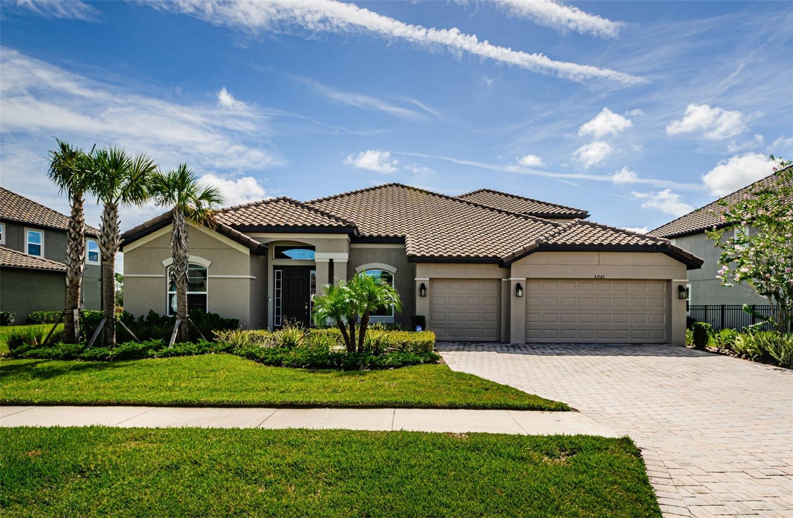 Introducing 33161 Kateland Drive, a residence of elegance and sophistication in the heart of Wesley Chapel’s most desirable community. Designed with refined living in mind, this home is set against a captivating pond backdrop, offering peaceful water views and a sense of privacy rarely found. The enclosed patio creates the perfect atmosphere for al fresco dining, morning coffee at sunrise, or intimate evening gatherings as the sun sets over the water.
Inside, every detail speaks of quality and comfort. Graceful tile flooring, soaring ceilings, and an open, light-filled design set the stage for luxurious everyday living. The primary suite is a true retreat, showcasing granite finishes, spa-like appointments, and a serene ambiance that promotes rest and rejuvenation. The gourmet-inspired kitchen is as functional as it is beautiful, with ample counter space, quality finishes, and seamless connection to the main living spaces, ideal for hosting family and friends.
The upstairs level unveils a generous bonus room and expansive game room area, providing versatility for entertainment, recreation, or a private retreat. Whether used for family movie nights, a home office, or quiet personal space, this level enhances both family connection and individual privacy.
From its tranquil water views to its elegant interiors, this home is more than just a residence— As you see the photos of the community with outdoor activities gives a sense of community and recreation for all. This home is a sanctuary that reflects the essence of the Global Luxury lifestyle. Conveniently close to fine dining, luxury shopping, Epperson Lagoon and top-rated schools, 33161 Kateland Drive offers the rare opportunity to enjoy everyday living with the feeling of a private retreat.