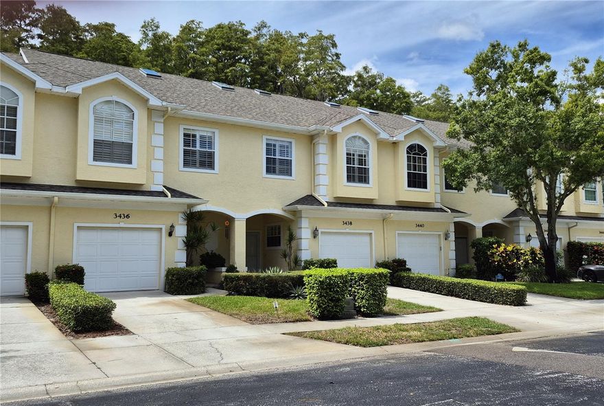 Rare townhome gem in gated Ashley Downs - an ideal location of Palm Harbor. Contemporary look, offers an open concept with high ceilings and awesome views of the conservation site wooded backdrop from the first floor tiled screen enclosed lanai AND the second floor screen enclosed wood deck off the primary bedroom. Tiled entrance foyer takes you to open area that includes spacious hall closet, half bath, entrance to private two car garage, closet pantry into open kitchen surrounded by spacious counter space, cabinets and breakfast bar into formal dining area that blends with the living area and sliding doors out to the lanai. Plantation shutters thru out! The second story has carpeted bedrooms. a guest bath and laundry closet with full size washer and dryer. The primary suite feels luxuriously large with its vaulted ceilings. Plantation shutters, planters shelf with hidden soft lighting and the screened balcony which overlooks the wooded conservation behind the unit. Barn sliding door into the primary bath that has a double sink vanity, separate walk in tiled shower and private commode. Spacious walk in closet. This townhome offers a private loft/office on the third floor with its own storage closet, vaulted ceiling with skylight. Community pool with gazebo, additional guest parking spaces near well desired schools, and a short drive to the beaches and parks.  Tenant pays first $100 for repairs.  Grounds maintenance, basic cable and internet is included in the rent.  This is a non smoking residence please.