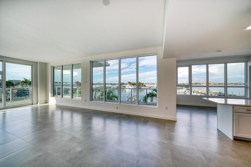 This south, southwest, and west facing residence offers over 180 degrees of sweeping waterfront views, spanning the marina, Intracoastal Waterway, bridges, and Clearwater Beach, with stunning sunsets year round. A 381 square foot wraparound balcony, accessible from all three bedrooms, provides an ideal setting for morning coffee, evening drinks, or entertaining. The open layout includes a separate den or bonus room and a well appointed kitchen with white all wood cabinetry, quartz countertops, a center island with seating, and a breakfast area that flows into the living room. The owner’s suite features a large walk in closet and a spacious bath with a walk in shower and dual shower heads, while two additional bedrooms offer generous walk in closets and share a separate guest bathroom. A dedicated laundry room is conveniently located off the den. Situated in a rare, newer luxury development directly on the Intracoastal Waterway, every residence enjoys water views, and this one truly stands out. The adjacent marina offers 69 boat slips, many with lifts, with residents receiving preferred access to lease slips at market rates. Resort style amenities include a saltwater lap pool with baja shelves, fitness center, sauna and steam rooms, putting green, clubroom with pantry, 24/7 concierge, and more, creating an exceptional waterfront lifestyle that must be experienced to be fully appreciated.