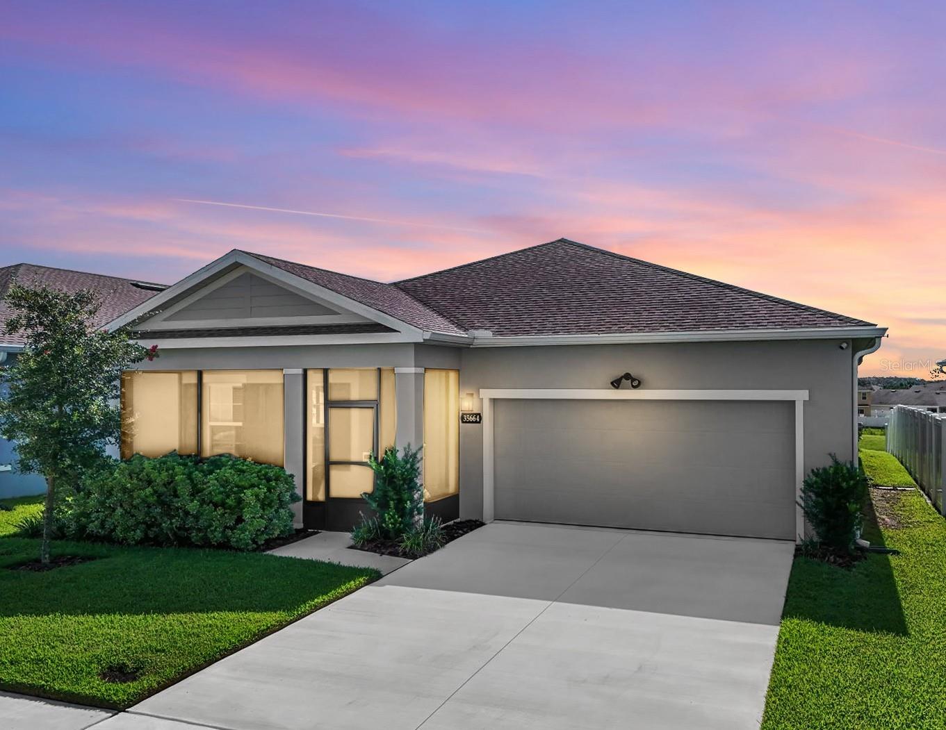 Come see this 3 Bedroom + DEN/Home office home with WATERVIEW! This 2023-built home in the desirable Chapel Creek community offers the perfect combination of modern comfort, stylish design, and a peaceful setting—complete with a stunning water view. From the moment you arrive, the inviting screened front porch sets the tone for the warm and welcoming atmosphere you'll find throughout the home. Step inside to an open-concept layout that flows effortlessly from room to room, ideal for both everyday living and entertaining.
The heart of the home is the beautifully designed kitchen, where Quartz countertops shine across the island and prep areas. Under-cabinet lighting adds the perfect touch of ambiance and function, highlighting the tile backsplash and creating a warm glow for evening gatherings. This space was made for hosting, with double ovens for holiday meals, a built-in cooktop, and a large pantry to keep everything organized. Enjoy your morning coffee or casual dinners in the dining area overlooking the extended lanai and tranquil pond view—an everyday reminder of the relaxing lifestyle that awaits. The lanai is a true highlight, offering plenty of room to unwind with friends or just enjoy a quiet evening outdoors. Outfitted with electrical, two ceiling fans, and cable hookup, it’s outdoor living at its best.
The split-bedroom layout offers comfort and privacy for everyone. The Primary Suite is tucked away at the back of the home and offers gorgeous water views from the bedroom, a spacious ensuite bath with dual sinks and a large shower, and a walk-in closet that feels more like a dressing room. Two secondary bedrooms are generously sized and share a full bath, while the fourth room offers flexible space for a home office, gym, or guest room—whatever fits your lifestyle best.
A dedicated laundry room offers convenience for everyday chores, while a separate utility sink in the garage is perfect for tackling messy tasks or quick cleanups. This nearly new home also features a whole-house surge protector for added peace of mind. Living in Chapel Creek means access to a community pool and playground, along with sidewalks for evening strolls and a sense of community that makes it easy to feel at home.
Located in the growing Zephyrhills area, you’re close to shopping, dining, schools, and major roadways, making it easy to get to Tampa, Wesley Chapel, and beyond. Whether you’re seeking serenity, convenience, or a beautifully designed space to call your own, this home delivers. Come see it in person and experience the Florida lifestyle you’ve been dreaming of.