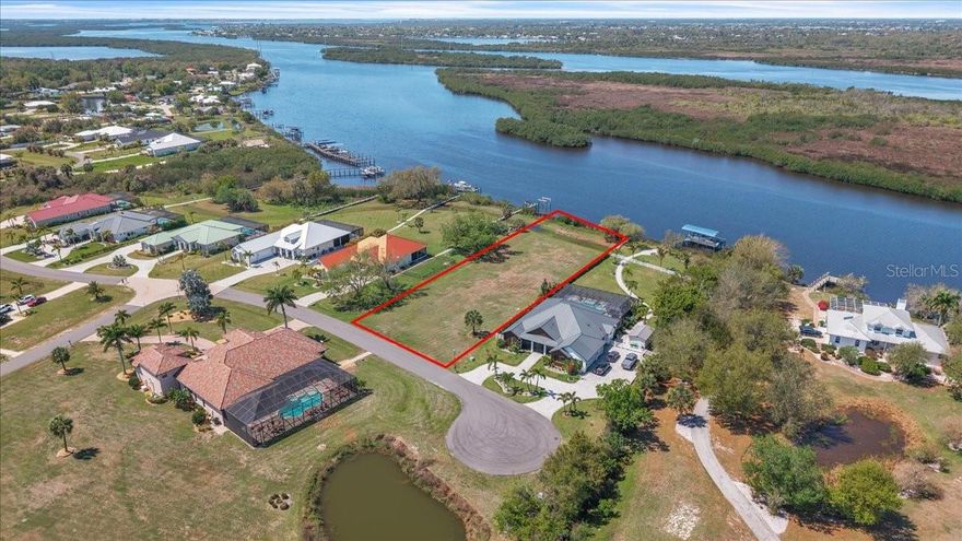 Own Your Slice of Waterfront Paradise in Punta Gorda! Seize the opportunity to own this stunning 1.03-acre waterfront lot in the highly sought-after Estates on Peace River, a private gated luxury community nestled between Fort Myers and Sarasota in scenic Southwest Florida. This extra-large homesite boasts 120 feet of water frontage, public water and sewer, and quick Gulf access with only two 40+ ft. bridges along the way. Situated on a quiet cul-de-sac surrounded by premium homes, the lot offers privacy, tranquility, and serene waterfront living. According to county records, no scrub jays are present on the lot at the time of listing. Residents enjoy assigned private boat docks on the Peace River, a community boat launch, and a tiki hut pavilion overlooking the river, perfect for gatherings or quiet relaxation. Homesites in this exclusive enclave are oversized, offering direct deep-water access, while custom homes feature modern coastal, Old Florida, or Mediterranean architecture with 3–4+ bedrooms, 3+ baths, private pools, and expansive lanais. Enjoy boating, fishing, and waterfront living while remaining just minutes from downtown Punta Gorda, shopping, schools, parks, churches, and I-75. With low HOA fees and a peaceful, exclusive setting, this is a rare opportunity to build your dream home on the Peace River.