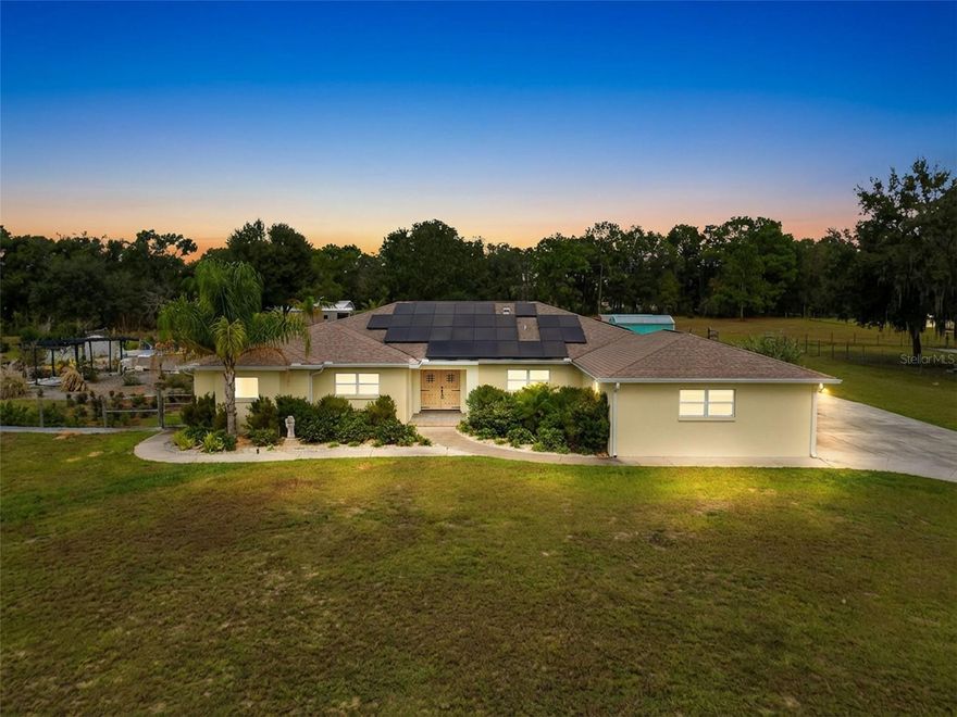 4.79 ACRES – 4/4/3 – POOL HOME with detached IN-LAW SUITE:   Custom-built in 2020 - Peaceful luxury, multigenerational living, and usable acreage. This 4BR/4BA home with 3,000 SF under roof sits on 4.79 acres of flat, fully fenced and cross-fenced land with mature oaks, several gardens, and plenty of room for animals, RVs, boats, and equipment.  This perfect family compound is not in an HOA or a Flood Zone.  The gorgeous handcrafted double front doors open into a large open-concept great room, featuring tile flooring, coffered ceilings, recessed lighting, and direct access to the screened pool and spacious lanai.   ADA-conscious design, solar power, and custom storage add everyday functionality.  The chef’s kitchen anchors the home with a 9-ft island, quartz counters, soft-close cabinetry, stainless steel appliances, under-cabinet lighting, and a walk-in pantry with California Closet organization. Imported Talavera tile adds unique character.  The private primary suite offers dual spa-style baths, two custom walk-in closets, and lanai access. Secondary bedrooms include tray ceilings, fans, and flexible ensuite options for guests or multigenerational living. A large laundry room, a mud room with built-ins, and a top-notch indoor pet bathing station.  Exceptional outdoor living features a screened lanai, a swimming pool with a sundeck, a spa, a sauna, and a full outdoor kitchen with granite counters and marine-grade cabinetry. Close by is the “Secret Garden,” an irrigated retreat with fruit trees, raised beds, herbs, flowers, and a firepit patio.  The property is divided into 5 functional zones, including hobby farming space with greenhouse, upscale chicken coop, garden, office, equipment building, a fenced pet area, and a detached 468 SF “In-Law Suite” beautifully designed with kitchenette, bath, shower, and screened porch—ideal for guests, office, studio, classroom, or a perfect in-law suite. Exceptional parking includes a 3-car garage, detached workshop with carport, and additional covered parking for up to 11 vehicles, plus room for trailers and RVs.  Conveniently located 10 miles south of Inverness and 10 miles north of Brooksville in friendly Floral City, Florida, with easy access to I-75, SR 589, and the Florida Turnpike—offering a perfect balance of privacy and accessibility.  Set up a showing to see this unique beauty in person; you won’t be disappointed.