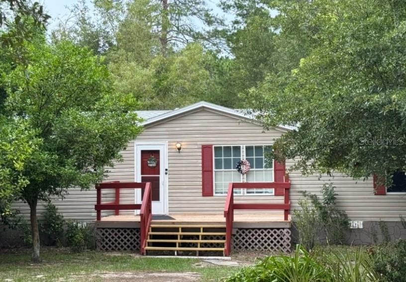 Spacious & Serene — 4BR + Office on 2.5 Acres! Tucked away on a peaceful 2.5-acre wooded lot, this beautifully updated 4-bedroom, 2-bath home offers over 2,000 sq ft of flexible living space—plus a dedicated office, formal dining room, and cozy den with a wood-burning fireplace. Inside, you'll find warm, modern finishes including newer laminate wood flooring throughout, vinyl in wet areas, and fresh interior paint (2023). The spacious primary suite features a new walk-in shower (2023) and a large soaking tub, creating your own private spa escape. A generous kitchen with eat-in space, walk-in pantry, and indoor laundry room provides comfort and convenience. This layout is ideal for today's lifestyle—with multiple living areas, room to work or homeschool, and plenty of storage. The washer and dryer will stay with the home for added value. Recent upgrades include a new roof and leach field (2019), HVAC ductwork and unit refurbishment (2024), full-house sealing by Terminix (2024), new fencing and raised 8x12 shed (2024), and a new front deck and storm door (2025). Enjoy the best of country living with a private well and septic, central heating and air, and no water issues—even during heavy rains or hurricanes. Outdoors, you'll find mature trees, open space, and fruit-bearing orange, lemon, kumquat trees and grapevines to enjoy. Whether you're dreaming of a homestead, family retreat, or peaceful escape with space to breathe—this home has the land, layout, and updates to make it happen. Bring your vision and step into the life you've been waiting for.