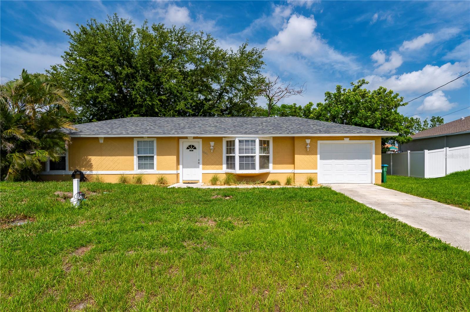 Welcome to this beautifully updated 3-bedroom, 2-bathroom home featuring an open floor plan perfect for modern living. The spacious kitchen is equipped with granite countertops, stainless steel appliances, and a large breakfast bar that overlooks the living and dining areas—ideal for gatherings and entertaining. Tile flooring runs throughout the entire home, offering both style and easy maintenance. All three bedrooms are generously sized with large closets, and there are several additional hallway closets providing ample storage space. Major updates include a complete HVAC system (2023), shingle roof (2023), updated electrical panel (2022), new water heater (2025), and a new thermostat. Both bathrooms were refreshed in 2025 with updated vanities and toilets. The attic received re-foamed insulation in 2023 along with all-new A/C ductwork, enhancing energy efficiency. The septic system was pumped and inspected in June 2025. This home also features a spacious 14x26 garage with a convenient back door entry, offering flexibility for storage, projects, or parking. Step outside to enjoy the large backyard shaded by beautiful mature trees—perfect for relaxing or outdoor activities. The home comes complete with storm shutters and easy-to-follow instructions for added peace of mind. Best of all, this property is not in a flood zone, giving you extra confidence and potentially lower insurance costs. This move-in ready home blends comfort, convenience, and thoughtful upgrades—don’t miss your opportunity to make it yours!