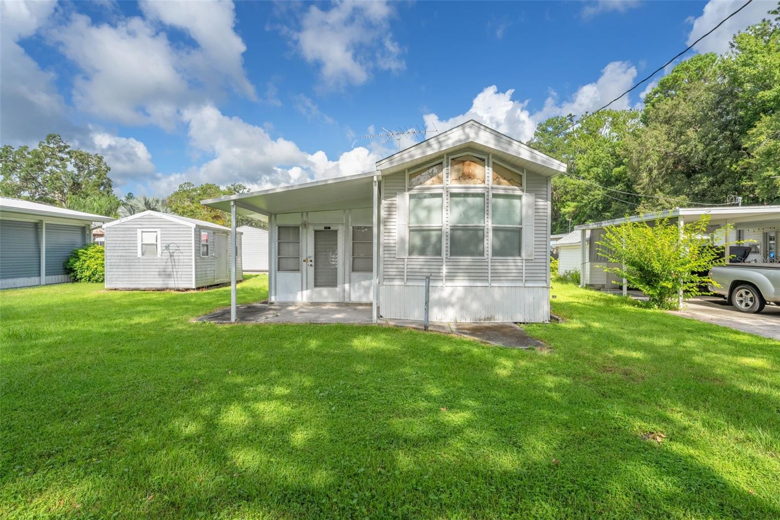 Searching for the perfect 55+ community in Florida where peace and comfort come together? Welcome to Camper's Holiday, a vibrant and
active neighborhood designed for those who want to enjoy the best of serene, Florida living. Surrounded by natural beauty, mature trees, and tranquil scenery, this gated community offers both privacy and convenience—just minutes from all that Brooksville has to offer. Enjoy an array of amenities including: complimentary internet and cable TV, a geothermal, Olympic-sized swimming pool for year-round relaxation, a recreational hall with a library, pool table, stage, and scheduled activities, large outside pavilion, fire pits, shuffleboard courts, playground and access to Sparkman Lake— the perfect spot for fishing, boating (with ramp), or soaking up the sun! Lot A-27 is ideally situated on a quiet, paved dead-end road and includes a 2002 Destination Trailer with full utilities, an outbuilding for extra storage, and comes fully furnished—just bring your personal items and settle in! Don't miss out on this move-in-ready opportunity in one of Florida's most peaceful 55+ parks. Call today to schedule your private showing!