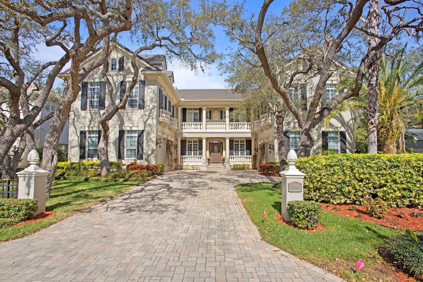 Do you desire a supremely luxurious custom home with five primary suites, a dream-worthy theater, an attached guest apartment, and an outdoor poolside oasis? Look no further! Beautifully tucked away in an exclusive area just moments from scenic Bayshore Boulevard, this 5BR/6.5BA, 6800+sqft residence immediately captivates the imagination with attractive custom architecture, a half-circle paver driveway, lush tropical landscaping, and towering mature trees, all sitting on a large double lot. Immaculately styled for the most discerning homeowner, the interior impresses with gorgeous oak hardwood floors with Brazilian cherry inlays, 12’ ceilings throughout the home, an openly flowing traditional layout, plantation shutters, thick crown molding, stunning wainscoting, living room with a fireplace, an elegant formal dining room, an exquisite mahogany-paneled home library/office, and a lovely music room, suitable for a baby grand piano. Catering to both foodies and gourmets, the Tuscan-inspired chef’s kitchen delights with premium stainless-steel appliances, custom wood cabinetry, granite countertops, gas range, center island, butler’s pantry, breakfast bar peninsula, and a breakfast nook. Unparalleled entertaining is discovered in the fully enclosed backyard featuring a sparkling pool, soothing spa, screened-in full outdoor kitchen, putting green, and a sprawling terrace. Indoor gatherings may also be enjoyed with the game/billiard room or the state-of-the-art home theater, which both enjoy wet bars. Bliss is found in the main primary bedroom boasting a romantic fireplace, two custom walk-in closets, and an en suite with stately columns, soaking tub, oversized multi-head shower with an attached steam shower room, and dual vanities. Multigenerational needs are satisfied with a guest/in-law suite featuring a full kitchen and full bathroom. Additional amenities include four garage parking spaces, laundry room with double washers/dryers, guest bedrooms with full bathrooms and walk-in closets, and so much more! Get all the advantages, and live your best life in one of Tampa’s most coveted areas. Bedroom Closet Type: Walk-in Closet (Primary Bedroom).