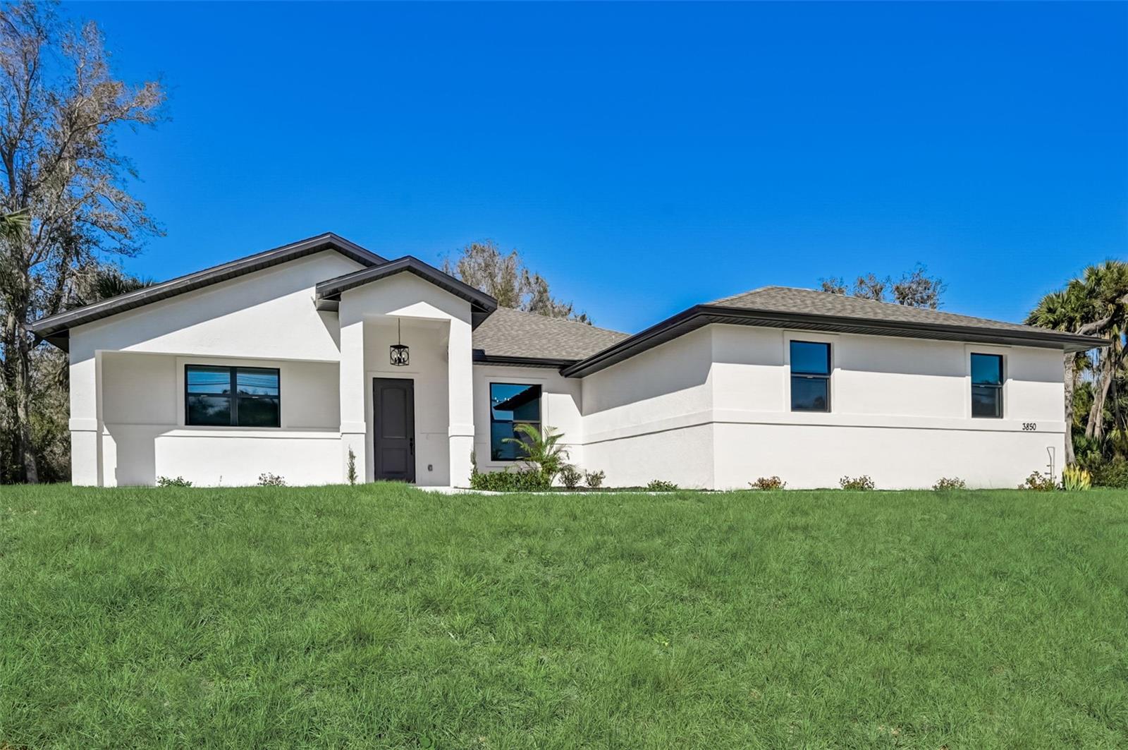 One or more photo(s) has been virtually staged. Price improvement! Motivated seller. Why wait to build? This beautiful new home is move in ready! The home sits on a double lot for privacy and plenty of room to create your dream front and backyard oasis. The home has almost 2500 square feet of living space that features a split floor plan with 4 bedrooms, 3 full baths, both have 2 full sinks, plus a den. Laminate flooring throughout, and tile in all the bathrooms. Upon entry, you'll be greeted by a grand entryway, open floor plan, trey ceilings in the dinning and living room, neutral paint, and an abundance of natural light. With a spacious open floor plan that seamlessly blends the living, dining, and kitchen areas, this home is perfect for entertaining guests or relaxing with your loved ones. The kitchen showcases quartz countertops, stainless steel appliances, and a large center island, perfect for culinary enthusiasts. Some of the highlights of this home are a large walk in pantry, oversized 2 car garage, spray foam insulation and hurricane impact windows! The oversized primary bedroom boasts a large walk-in and built-in closets, a spa-like bathroom with dual vanities. On the opposite side of the home, two additional spacious bedrooms share a guest bathroom with dual sinks. This property is close to shopping, dining, Sarasota Memorial Hospital, desirable school district, and 20 minutes to the beach. Don't miss your chance to schedule a showing and discover your new dream home!