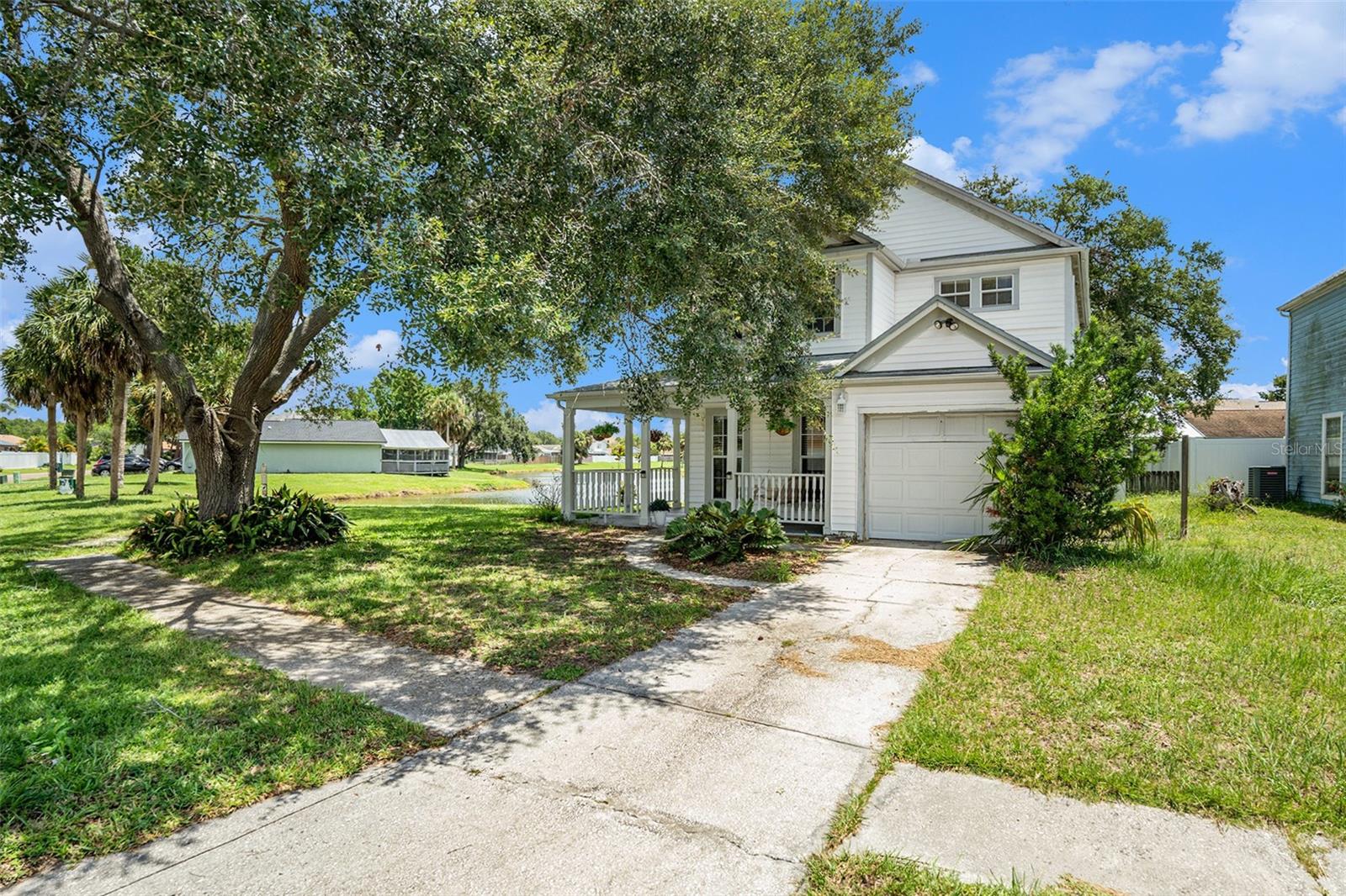 One or more photo(s) has been virtually staged. Welcome to 11017 Springridge Dr, where peaceful pond views and charming curb appeal come together to create the perfect place to call home! Tucked into a quiet street in the heart of Carrollwood, this beautiful 3-bedroom, 2.5-bath two-story home offers serene surroundings and a layout made for both everyday living and entertaining. Step onto the covered front porch that wraps around the left side of the home — perfect for rocking chairs, morning coffee, or decorating for the seasons. Inside, you'll find a warm and inviting layout with all three bedrooms upstairs, offering added privacy and separation from the living spaces below. Downstairs, enjoy a bright and open main living area, a dedicated dining space, kitchen, and a convenient half bath for guests. The heart of the home flows seamlessly out to the screened-in back patio, where you’ll love relaxing with or hosting a weekend barbecue — all with stunning views of the peaceful pond just beyond your backyard. This home truly has the feel of a private retreat while still being close to everything — top-rated schools, shopping, dining, and major roads for an easy commute. Whether you’re sipping coffee on the porch, watching the sunset over the water, or entertaining under the stars, Springridge Dr offers the lifestyle you’ve been waiting for. Don't miss this rare Carrollwood gem — schedule your showing today and fall in love with the view!