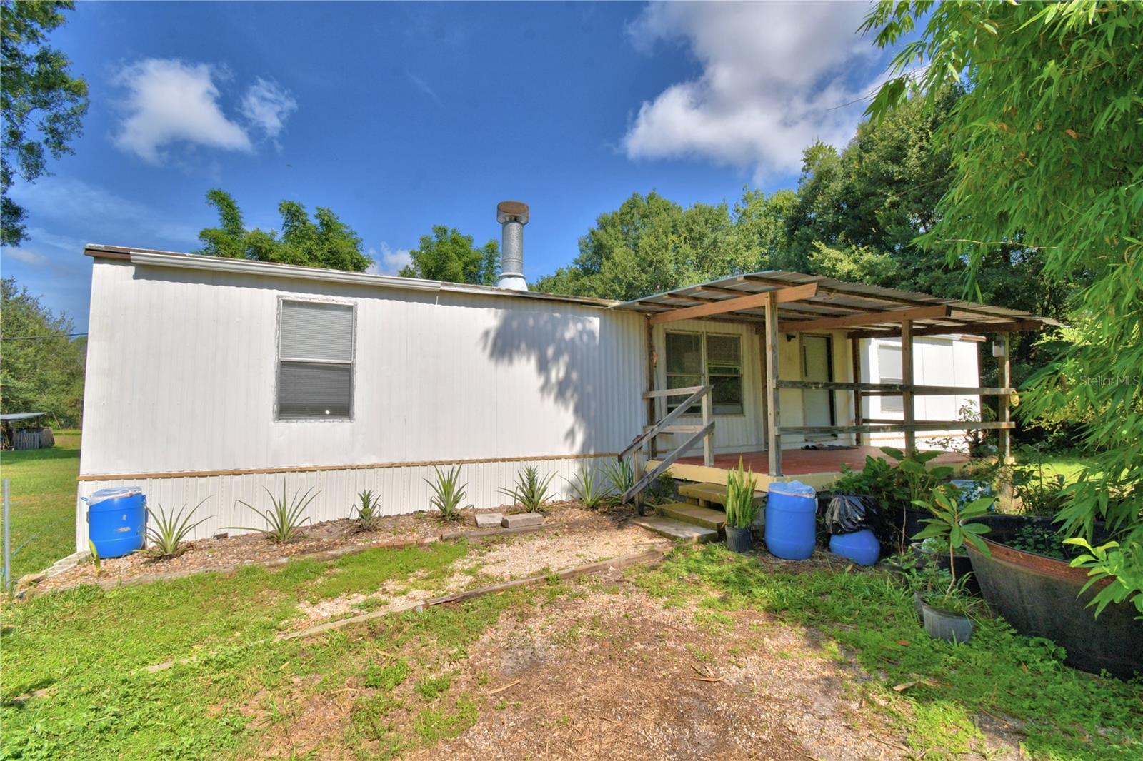 Living the country life in North Lakeland! Nestled on 2.01 acres in Polk County, this 3-bedroom, 2-bath home features an open-concept layout, a cozy fireplace, and a charming front porch. Set in a peaceful rural setting, the property offers ample space and potential for future development. Zoned for residential use, it allows for either a single-family home or a mobile home (subject to county approval). Electricity and water are already connected. Additional features include a beautiful pond, mature trees, a shed for added convenience. Located near major roadways with easy access to Orlando, Tampa, and surrounding areas. Don’t miss this opportunity—bring your vision and explore the possibilities! Buyer and buyers agent to verify all property details and conduct site visits as needed. Call for a private showing TODAY!!