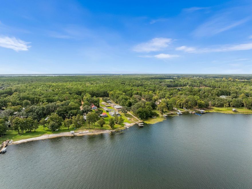 Come home to Florida lakefront living at its best! Welcome to the cool clear waters of Lake Lilly and this nearly new well built three bedroom and two bathroom home with stunning views. Wood lined cathedral ceilings greet you as you enter the light filled great room from the front porch with unobstructed views through the open concept dining, kitchen, and living area to the sprawling back porch and out to the covered dock. The kitchen is an entertainer's dream with a massive island, granite counters, stainless appliances, and a gas cooktop. A luxurious primary suite offers lake views, covered porch access, two walk-in closets, and a spa like bathroom with oversized shower and a walk-in soaking tub. The split floorplan includes two additional large bedrooms and a spacious bathroom. Boating is a breeze with the private ramp and covered storage complete with full 30 amp RV hookups. No detail was overlooked and no expense spared when building this lakefront retreat from the world. A solar panel system contributes to energy efficiency, and everything runs as usual during prolonged power outages thanks to the whole house generator with a 1,000 gallon in-ground propane tank. The air conditioned garage includes workshop space with stainless sinks and plenty of room to store more than cars. A carport and two sheds provide covered parking and storage near the house, and there's another by the dock for easy access to all those water toys and floats. Lake Lily is a private spring fed lake in the heart of north central Florida's lake region with easy access to Gainesville, Jacksonville, and Ocala. Nearby Melrose and Keystone offer many great dining and shopping options. Call today to see this amazing property for yourself!