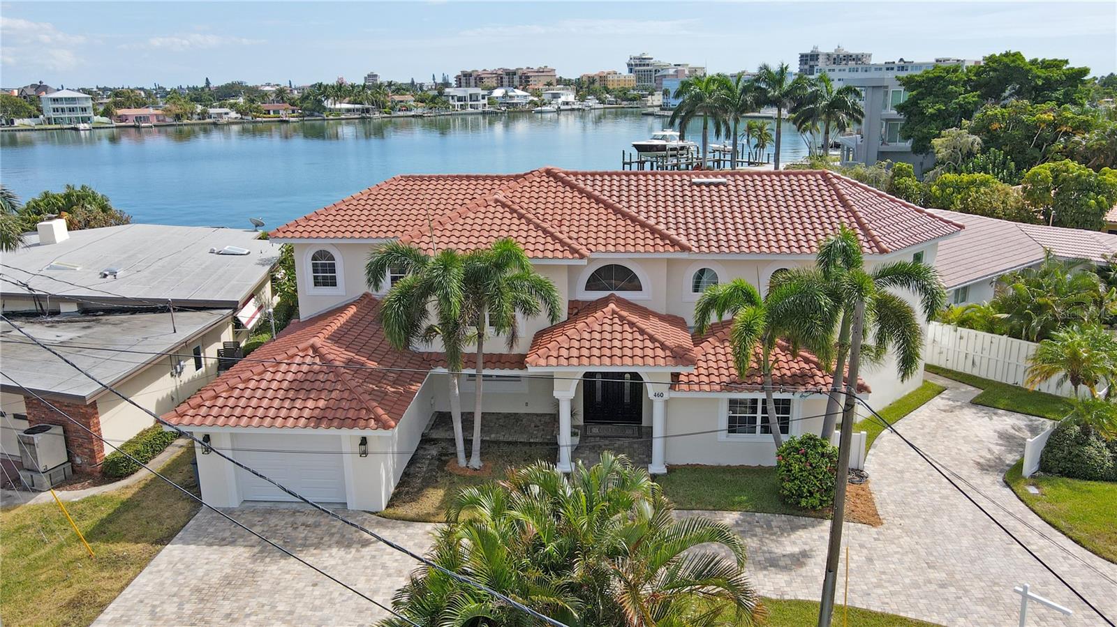 Gorgeous 5BR/5BA waterfront home in sunny St Pete Beach with STUNNING Open water views! This property offers a short walk, bike ride, or golf cart journey to one of the country's most stunning beaches! Walking through the entry of this home, you will be greeted by a vaulted foyer with high ceilings and a beautiful chandelier. This home speaks elegance & luxury with a spacious, open floor plan and beautiful panoramic water views of Boca Ciega Bay. The Living room area is spacious and bright with large windows and French doors leading out to the pool area overlooking the Bay. The Kitchen features gorgeous custom wood cabinetry, quartz countertops, ceramic tile floors, a built-in oven/microwave, stainless steel appliances, a center island w/ hood & cooktop, a walk-in pantry plus plenty of countertop space for food prep and entertaining. Adjacent to the kitchen is a dining room that accommodates a large dining table overlooking the pool, backyard & bay. There is an oversized laundry room with extra storage closets leading into the newly built garage. Also on the 1st floor is a Master bedroom w/en-suite bathroom and French doors that connects to the pool/lounge area. An additional 2nd bedroom & bathroom is located on the 1st floor as well. Heading up the decorative wooden stairs to the 2nd floor, there are 2 Master bedrooms with brand new modern flooring & 2 en-suite master bathrooms with oversized bathtubs and a separate walk-in shower. Adjacent to the Master bedrooms is a cozy loft space perfect for an office space or TV lounge. Enjoy a split floor plan layout between 1st & 2nd floor bedrooms in this home. The added “BONUS” is an exquisite, brand new 2-story guest suite/casita added to the home in 2023 featuring an impeccably crafted space with amazing water views including an oversized Master bedroom, full-size ensuite bathroom, living room, laundry room, and walk-in closet. This brand-new addition with modern finishes also features a full-sized kitchen with stainless steel appliances, quartz countertops & dinette along with a private entry and dedicated parking. Perfect for guest accommodations, mother-in-law suite, or long-term rental opportunity for extra income! Stepping outside into the private, vinyl-fenced backyard, it is a beautiful sanctuary with a pool, garden, outdoor shower, lounge seating, and dining area, all of which is perfect for entertaining or lounging while enjoying the magnificent views of Boca Ciega Bay. This waterfront property features a dock leading to deep sailboat water plus only minutes to the Gulf of Mexico by jet ski or boat. The wrap-around driveway features gorgeous multi-color pavers complimenting the beautiful tile roof and custom landscaping giving this home beautiful curb appeal. This property is a few minutes from the Gulf of Mexico beaches, multiple restaurants, and shops and only 15 minutes to downtown St Petersburg. Priced to SELL, Don’t miss this beauty!