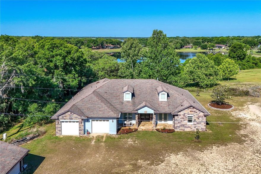 A rare offering for the discerning buyer, this one-of-a-kind custom estate is set on nearly 7 pristine acres in a private, lakefront setting beyond the constraints of city living.

Meticulously designed and masterfully built, the residence showcases exceptional craftsmanship and uncompromising quality throughout. At its center, a showpiece chef’s kitchen features bespoke custom wood cabinetry, striking Madura Gold granite, a 48” Wolf dual-fuel range with infrared grill and charbroiler, Sub-Zero refrigeration, and a custom-built bar with integrated sink, designed for elevated entertaining.


The home is constructed for both comfort and efficiency with wall to wall Icynene insulation, engineered hardwood flooring throughout, and refined custom window treatments. The primary suite is a private sanctuary, anchored by a custom gas fireplace and complemented by a spa-caliber bath adorned with rare Crystal Murano Schist countertops and a tankless water system.

On the opposite wing of the home is situated two guest beds and 2 guest baths, as well as an oversize laundry/utility room.

Seamlessly blending indoor and outdoor living, a 700-square-foot enclosed lanai with natural sandstone flooring offers a serene vantage point to enjoy the estate’s tranquil surroundings.

Beyond the main residence, the property continues to impress with a detached garage perfect to utilize as a guest apartment if desired, complete with central air and plumbing, ideal for extended stays or private accommodations. Equestrian amenities include a 4-stall horse barn, while an additional well, septic, and electric hookup provide the infrastructure for future expansion or a secondary residence.

Private. Refined. Unrepeatable. This is a legacy property offering the rare combination of luxury, land, and lakefront living.

Centrally located yet wonderfully private, the property is approximately one hour from Orlando International Airport and the renowned World Equestrian Center in Ocala, making it equally suited for a refined rural residence or an equestrian-focused retreat.
11 additional acres also available to purchase, MLS #'s G5107810,G5107866.