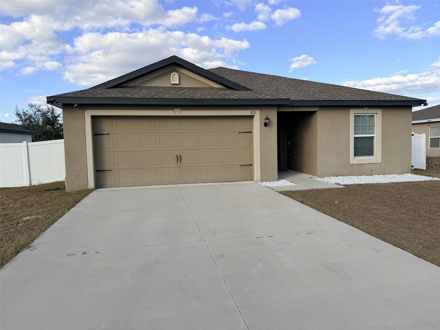 Welcome to 313 Camellia Ct in Poinciana, FL — a 2022-built home that feels like new without the wait for construction!

Why wait months for new construction, pay additional lot premiums, and live through the build process when you can move into this like-new home today — complete with upgrades already in place?

This move-in ready 3 bedroom, 2 bathroom home with a 2-car garage is ideal for a first-time home buyer looking for modern finishes, low maintenance, and affordability in Central Florida. With 1,419 sq ft of heated living space, the open floor plan connects the kitchen and family room — creating a bright and functional space for everyday living and entertaining.

The kitchen features granite countertops, 36” upper cabinets with crown molding for added height and style, and a full appliance package including range, refrigerator, microwave, and dishwasher. Granite continues into both bathrooms, giving the home a cohesive and upgraded feel buyers love. Vinyl flooring throughout the main living areas keeps the space stylish and easy to maintain.

Step outside to your fully fenced backyard — something many new construction homes do not include. Perfect for pets, kids, entertaining, or added privacy.

The spacious primary suite includes a walk-in closet and private bath. Two additional bedrooms offer flexibility for guests, a home office, or a growing family.

Built in 2022 with concrete block construction, shingle roof, central air, public water and sewer, and located in Flood Zone X (typically no flood insurance required by lenders), this home offers peace of mind and lower ownership costs. Low HOA and no CDD help keep monthly payments manageable — ideal for buyers transitioning from renting to owning.

Located in Poinciana Neighborhood 2 Village 8, residents enjoy parks, playgrounds, and recreational amenities. Convenient access to Haines City, Davenport, Lake Wales, and commuting routes toward Orlando makes this location attractive for buyers seeking value without sacrificing connectivity.

If you're searching for:
• Homes for sale in Poinciana FL
• 3 bedroom homes under $300,000 in Polk County
• Homes with granite countertops
• Homes with fenced backyard
• First-time home buyer homes in Central Florida
• Move-in ready newer construction resale

This home checks all the boxes — and it’s available now.

Schedule your private showing today and start building equity instead of paying rent!
